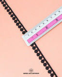 The black 'Edging Ball Lace 21554' is pictured with a ruler on it measuring its size which is 0.5 inch