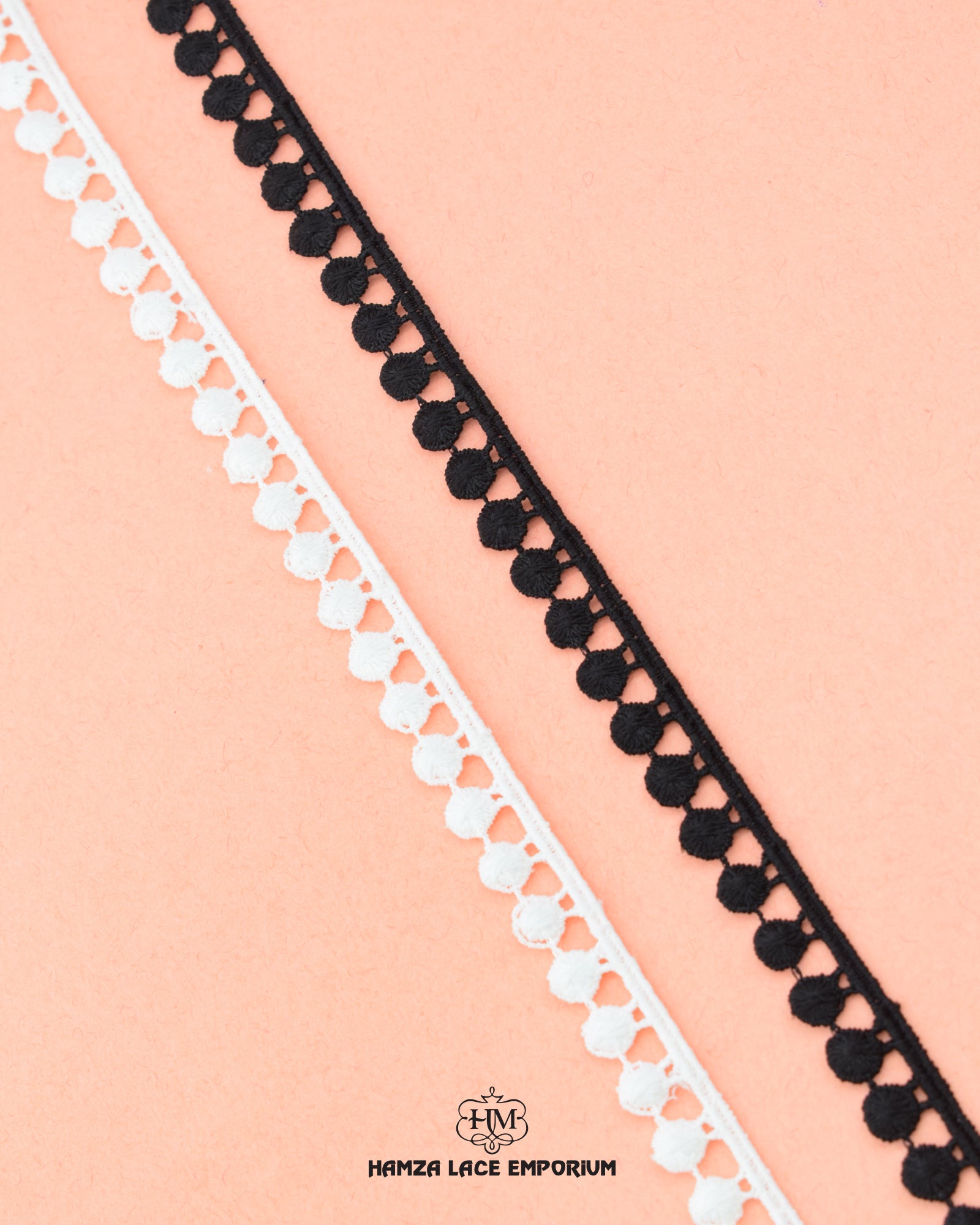 Two  pieces of 'Edging Ball Lace 21554' is placed on a piece of cloth