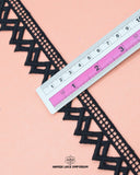 A scale is on the 'Edging Lace 21622' measuring its width size which is 1.25 inches