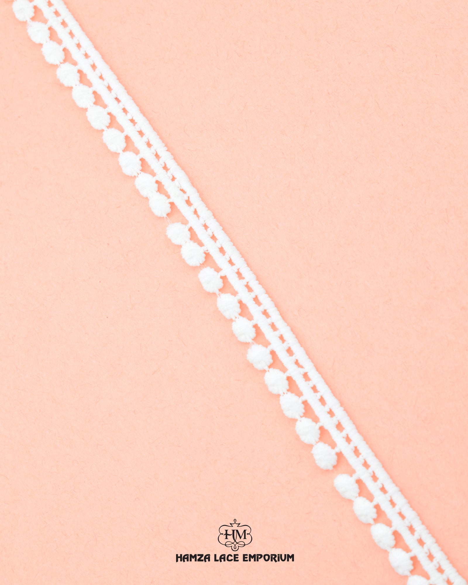One white piece of the 'Edging Ball Lace 21660'  with the 'Hamza Lace' sign