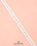 One white piece of the 'Edging Ball Lace 21660'  with the 'Hamza Lace' sign