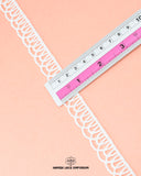 A ruler is on the 'Edging Scallop Lace 23135' measuring its size as 0.75 inches