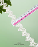 A scale is placed on the 'Edging Samosa Lace 23234' for the purpose to show its size that is 1.5 inches