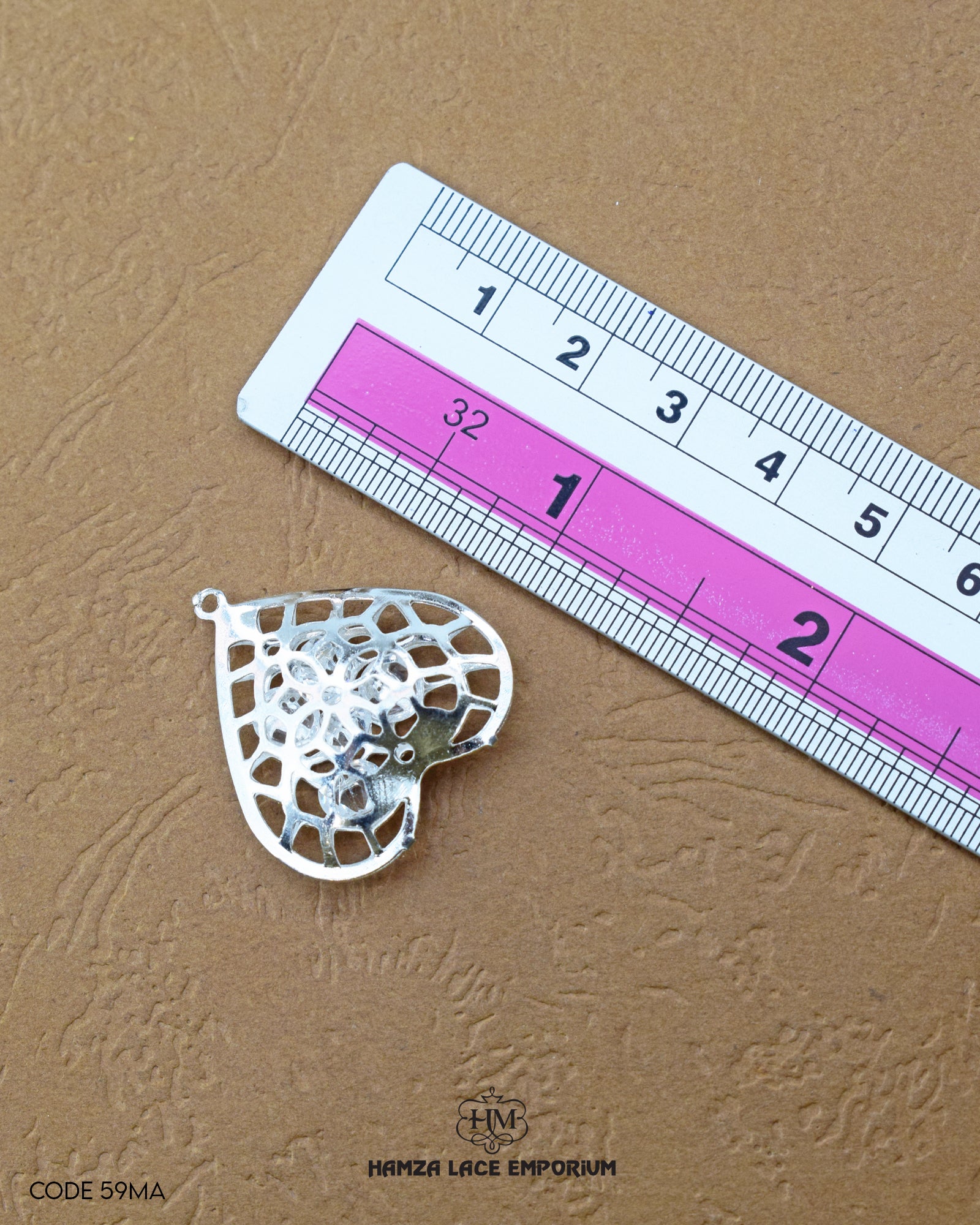 The 'Heart Design Metal Accessory MA77' size is showcased using a ruler for precise measurement.