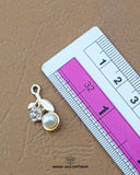 'Hanging Pearl Button 141FBC' with a ruler placed alongside it to showcase the size.