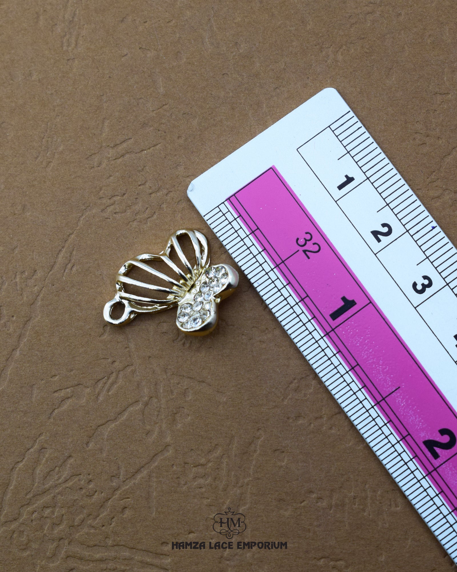 'Hanging Pearl Button 225FBC' with a ruler placed alongside it to showcase the size.