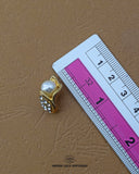 'Button 278FBC' with a ruler placed alongside it to showcase the size.