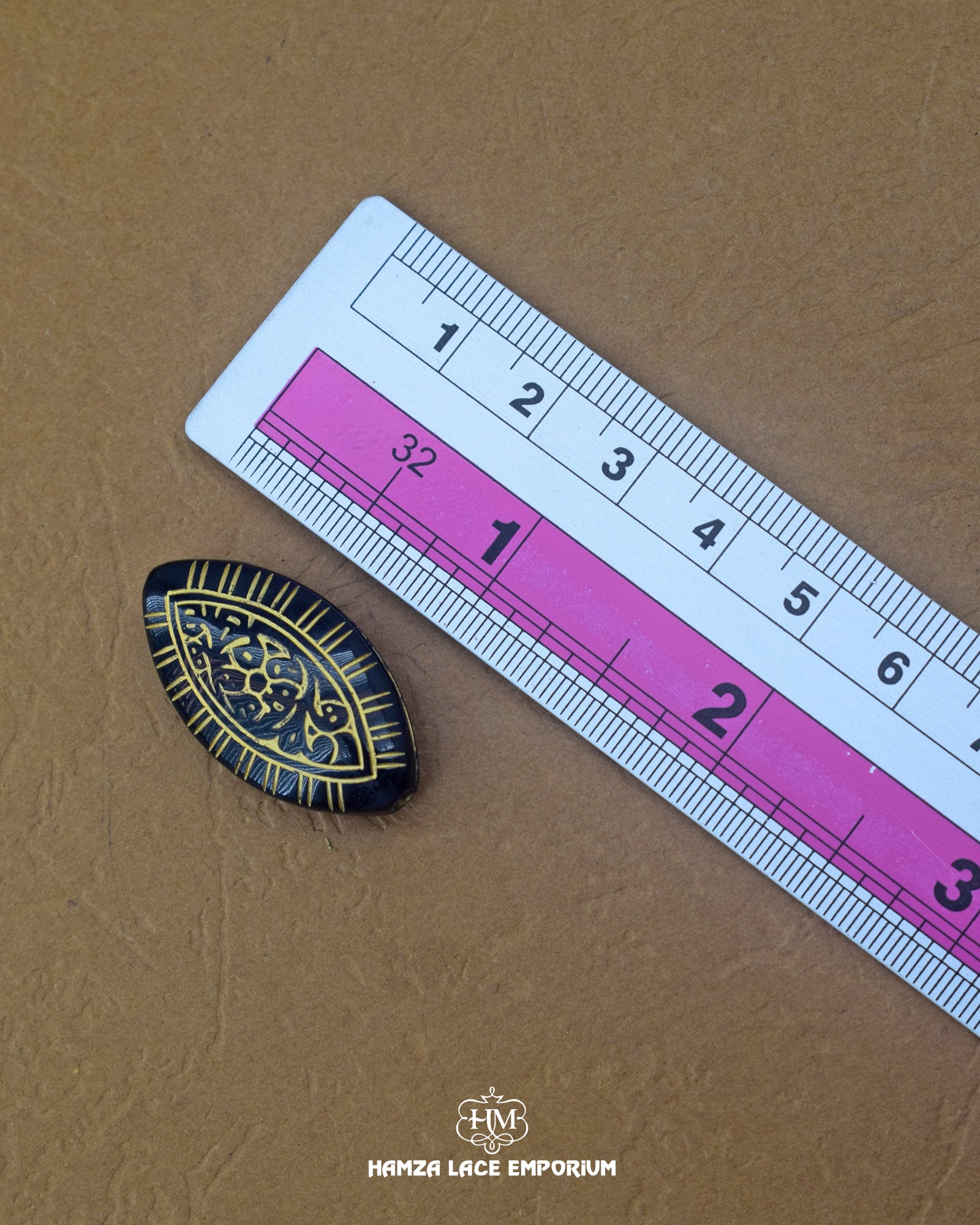 The size of the Beautifully designed 'Oval Shape Button MA329' is measured by using a ruler