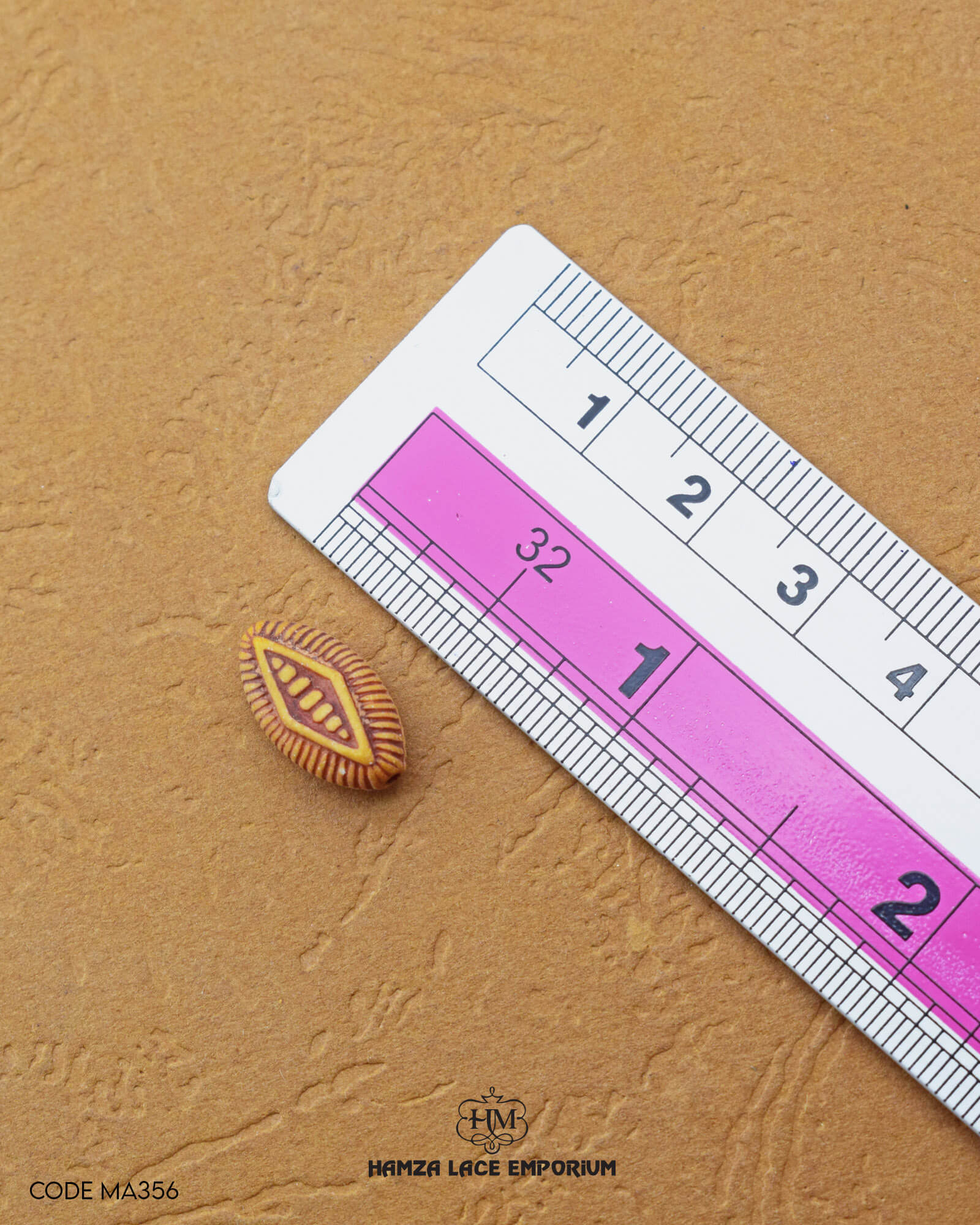 'Kite Shape Button MA356' with a ruler placed alongside it to showcase the size.