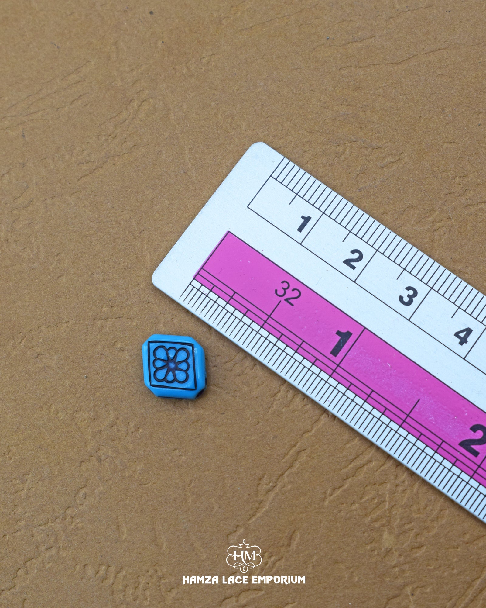 The size of the Beautifully designed 'Kite Design Button MA372' is measured by using a ruler