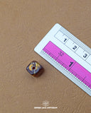 The size of the Beautifully designed 'Square Design Button MA382' is measured by using a ruler