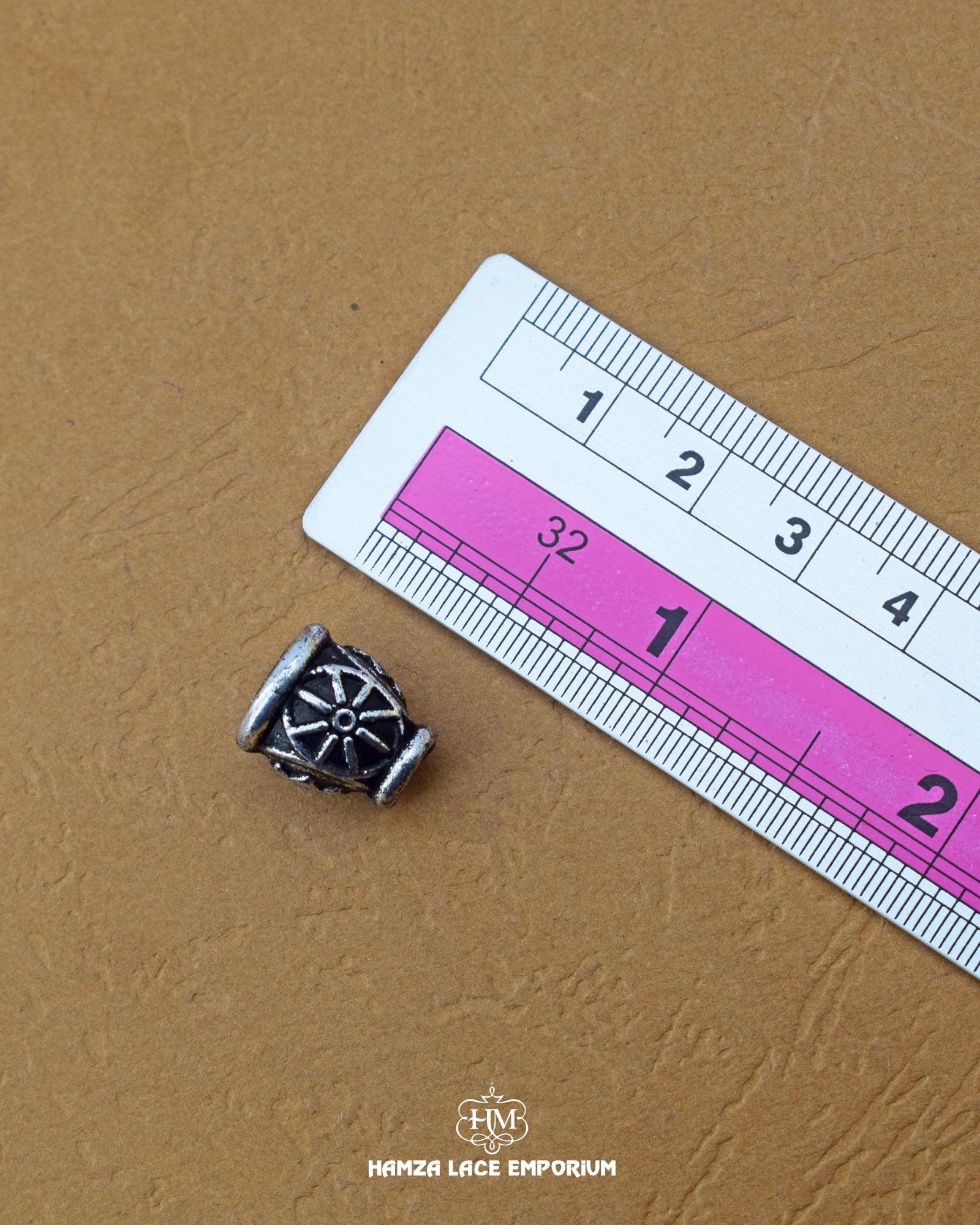 The size of the Beautifully designed 'Hanging Button MA387' is measured by using a ruler