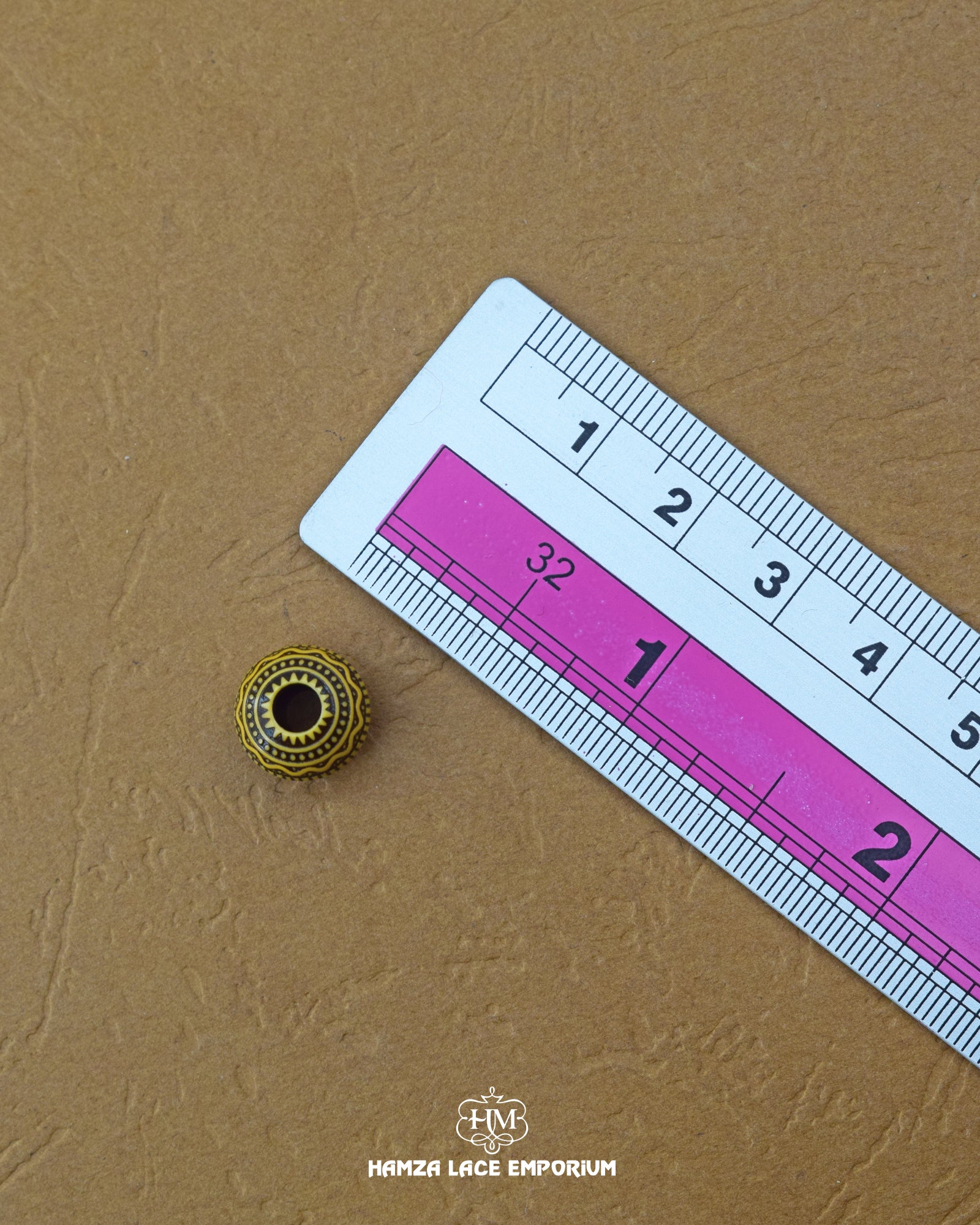 The size of the Beautifully designed 'Loop Design Button MA391' is measured by using a ruler