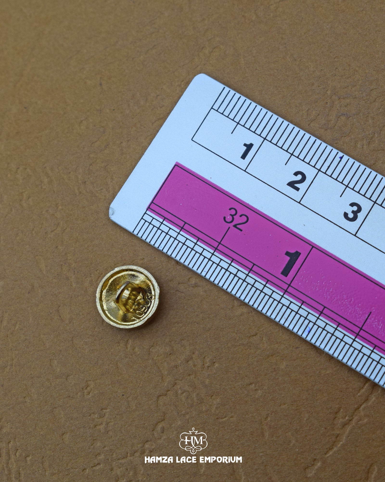 The dimensions of the 'Round Shape Button MB131' are determined using a ruler.