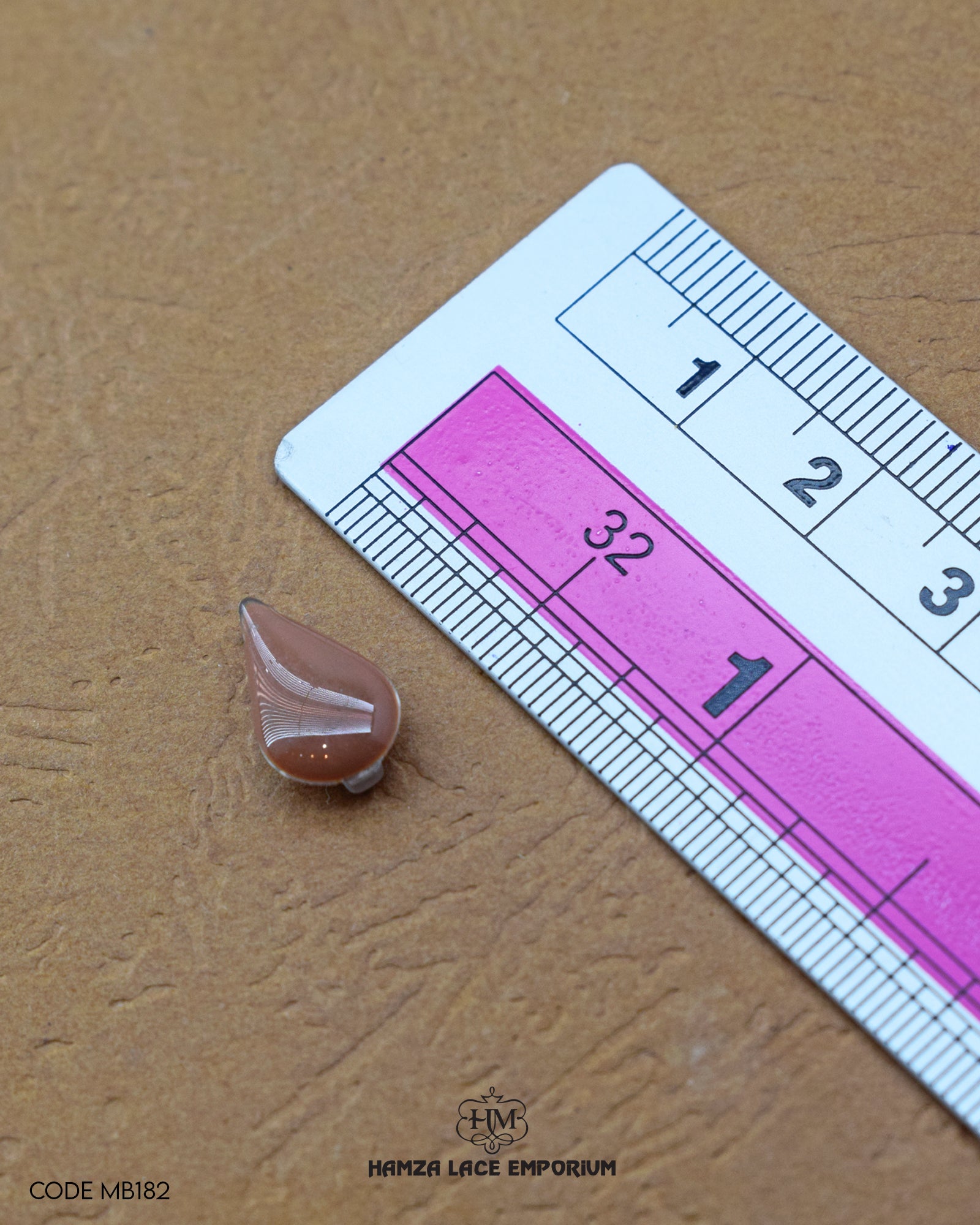 The size of the 'Drop Shape Metal Button MB182' is measured using a ruler.