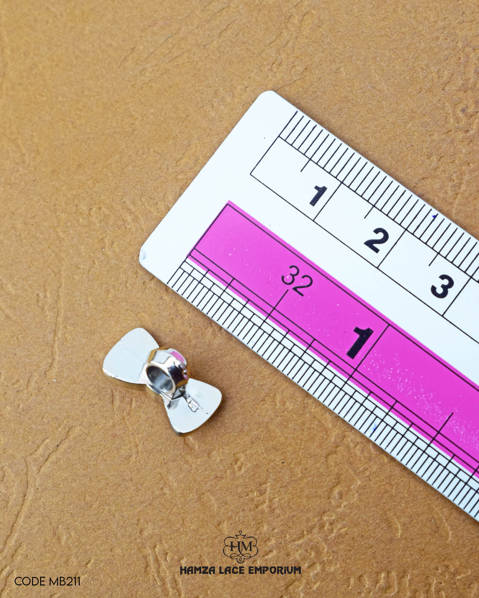Size of the 'Tie Design Button MB211' is given with the help of a ruler