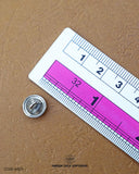 The size of the 'Plane Metal Button MB29' is measured using a ruler.