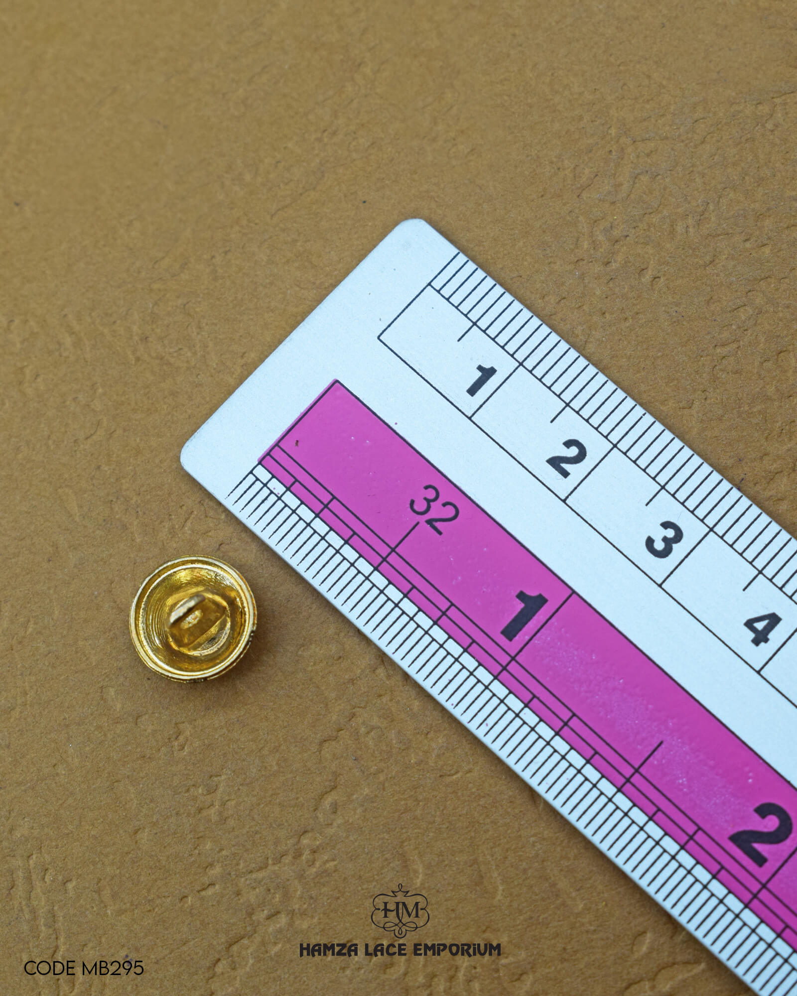 The size of the 'Golden Metal Button MB295' is measured by using a ruler