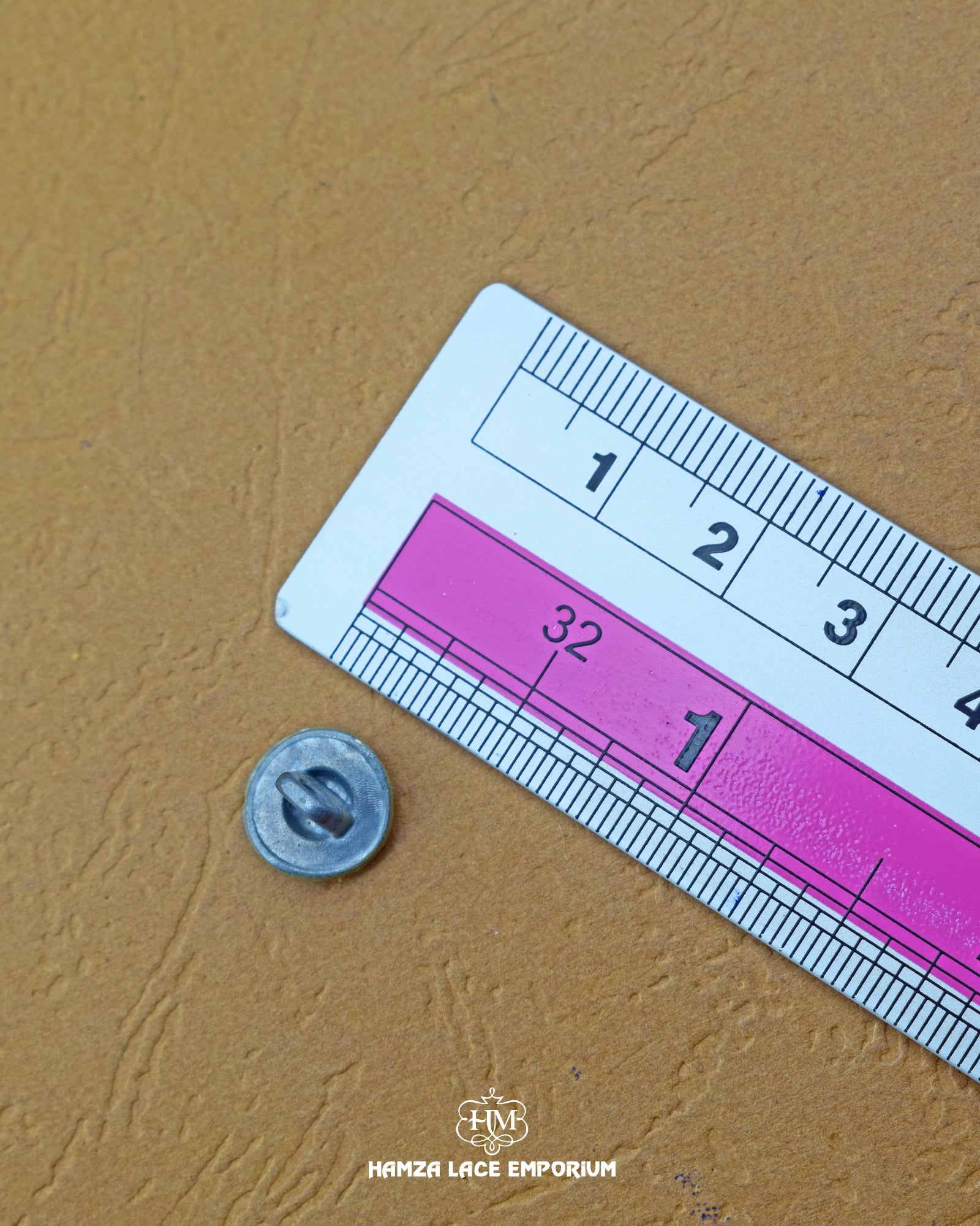 Size of the 'Loop Shape Metal Button MB2' is given with the help of a ruler