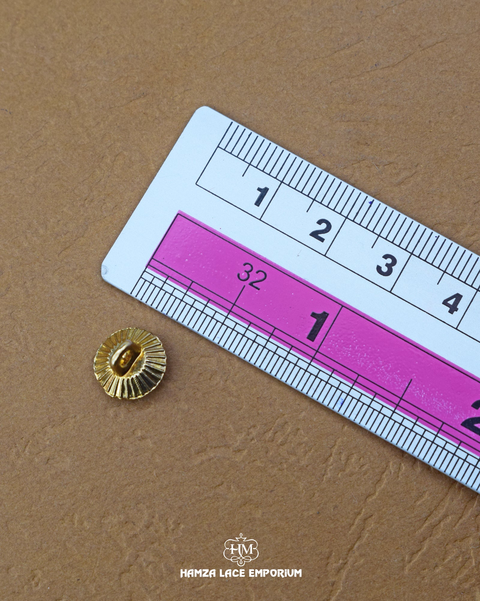 The size of the 'Golden Metal Button With White stone MB33' is measured using a ruler.