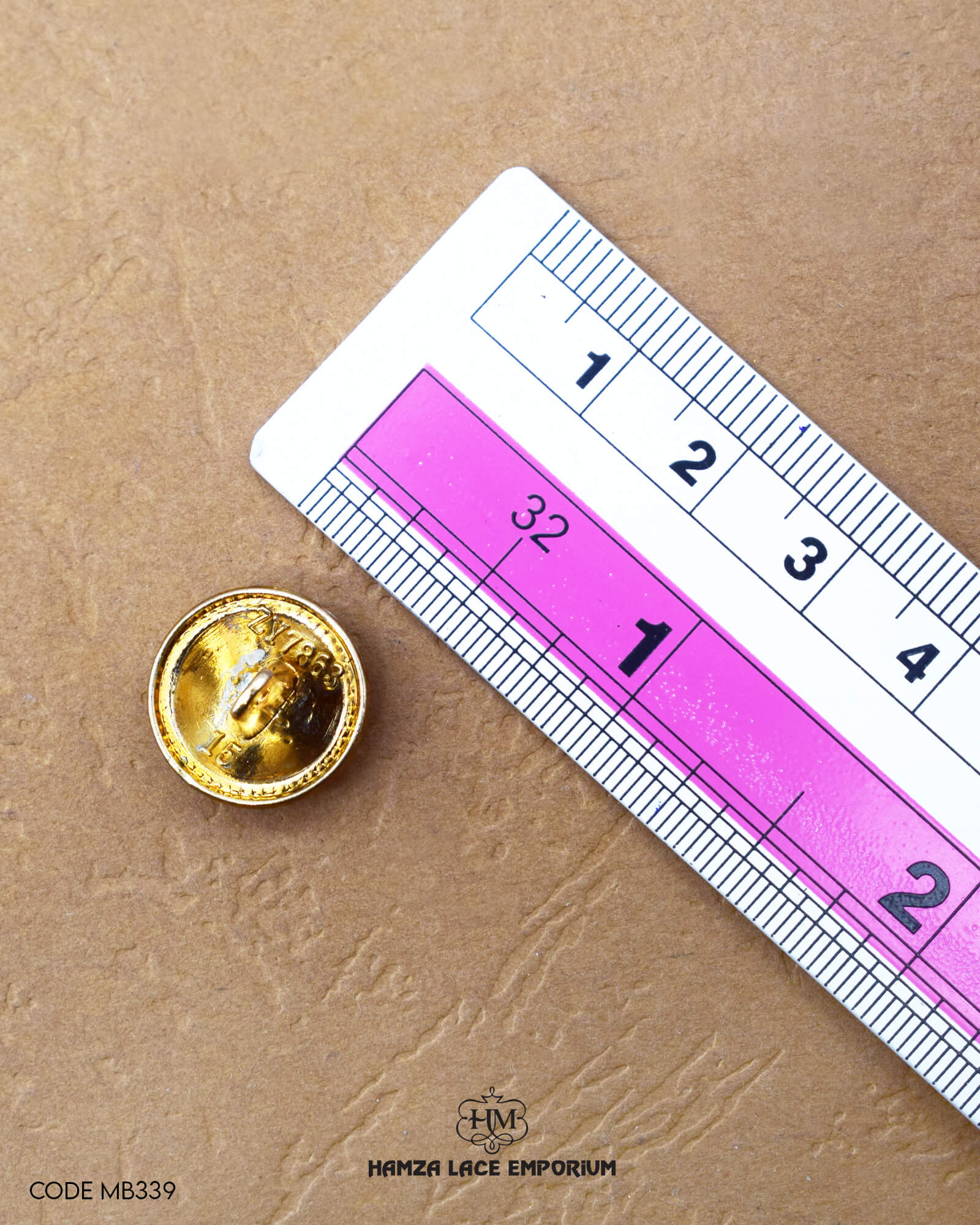 The size of the 'Golden Metal Button MB339' is measured by using a ruler