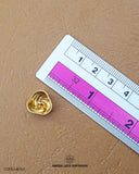 The size of the 'Flower Design Metal Button MB343' is measured using a ruler.