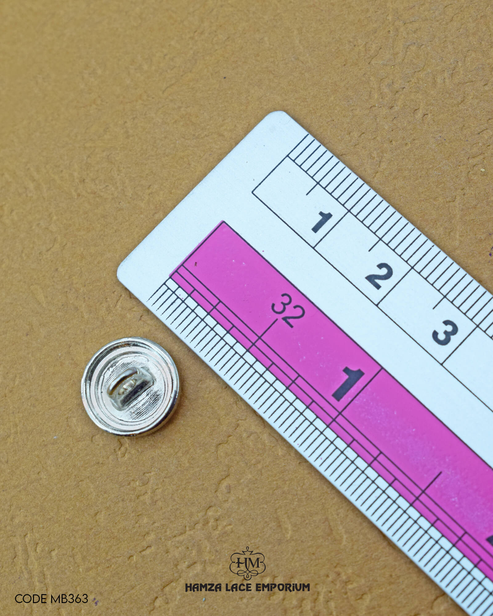The size of the 'Metal Silver Button MB363' is measured using a ruler.