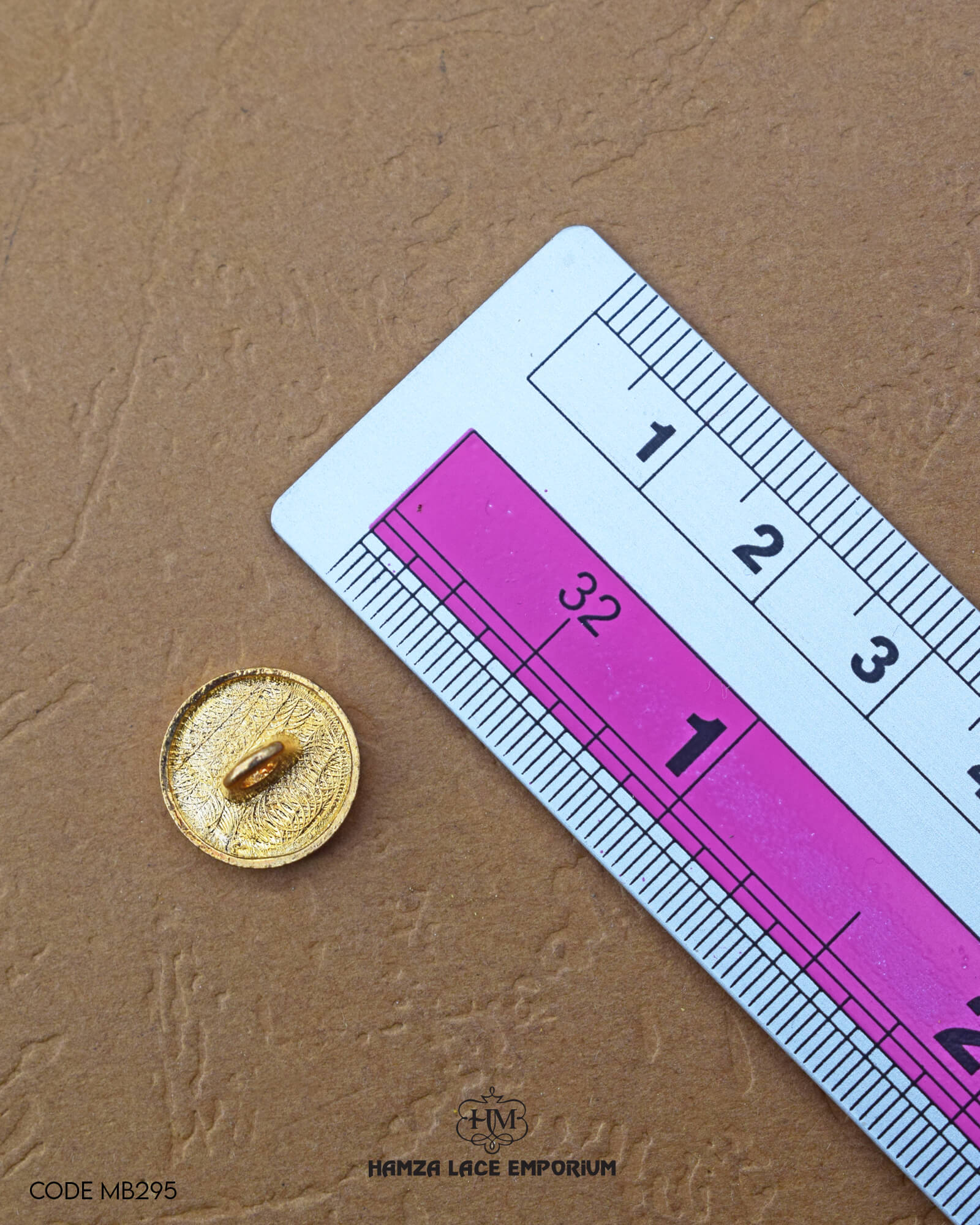 Size of the 'Golden Metal Button MB373' is given with the help of a ruler