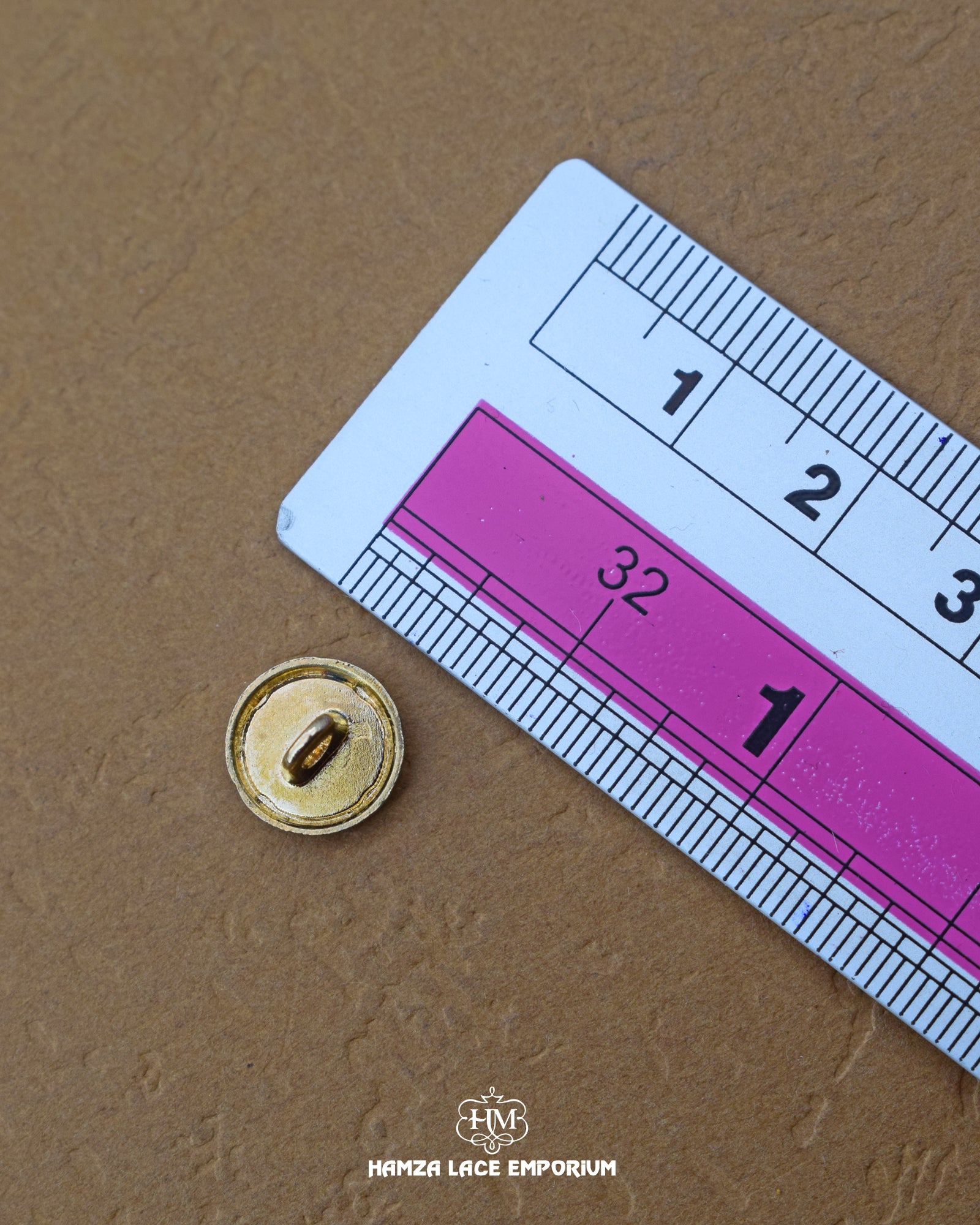 The dimensions of the 'Double Shade Button MB374' are determined using a ruler.