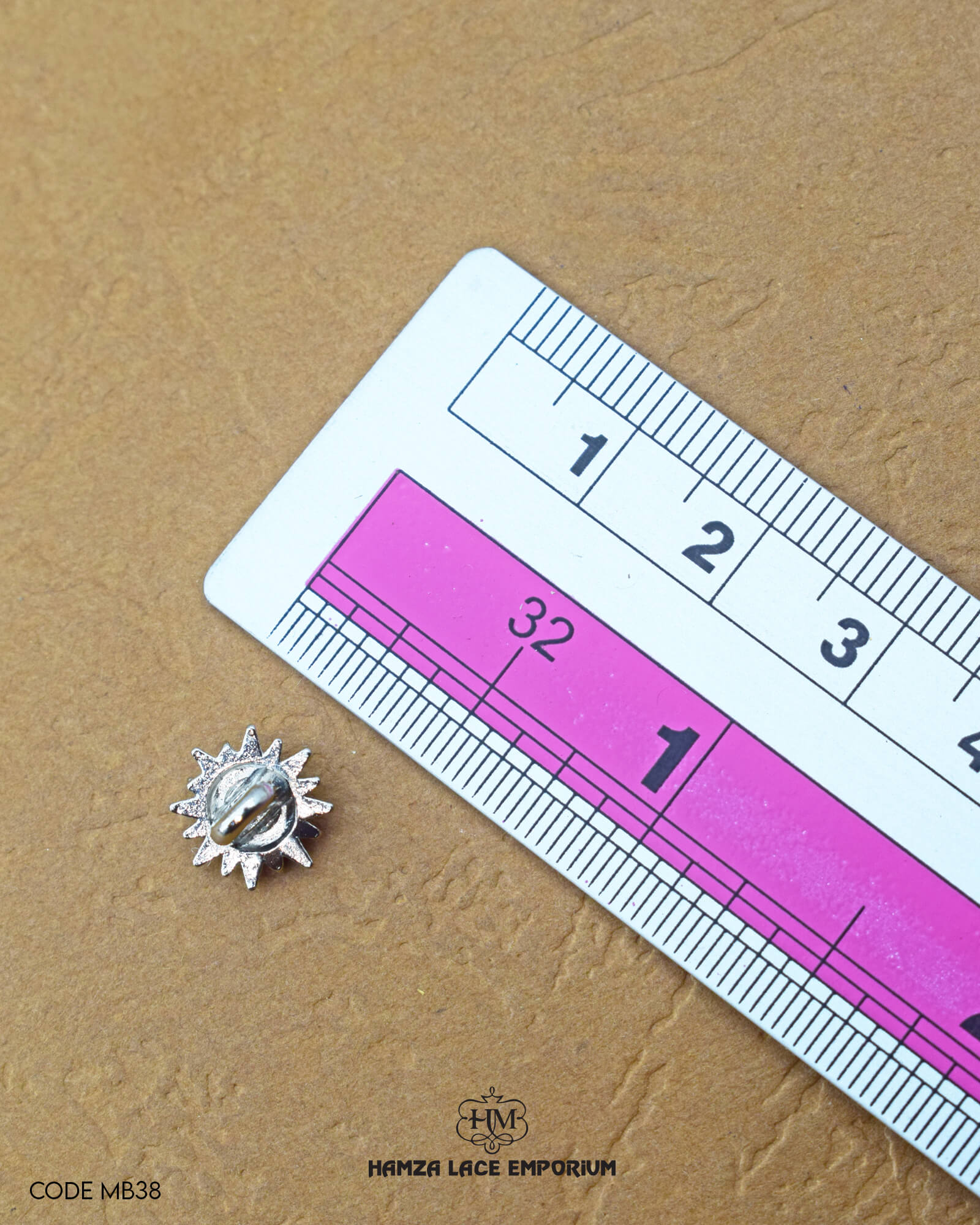 The size of the 'Flower Design Metal Button MB38' is measured using a ruler.