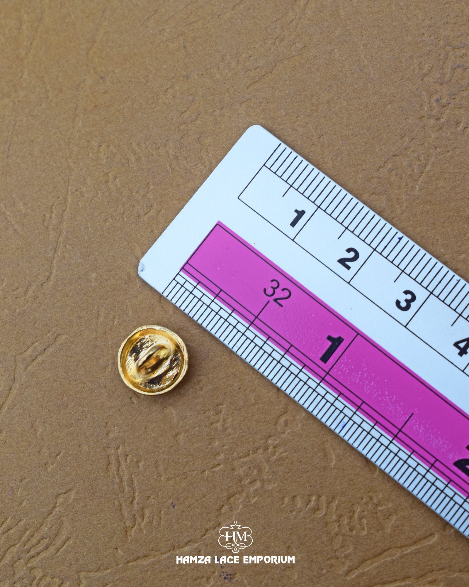 The size of the 'Golden Metal Button MB380' is measured by using a ruler