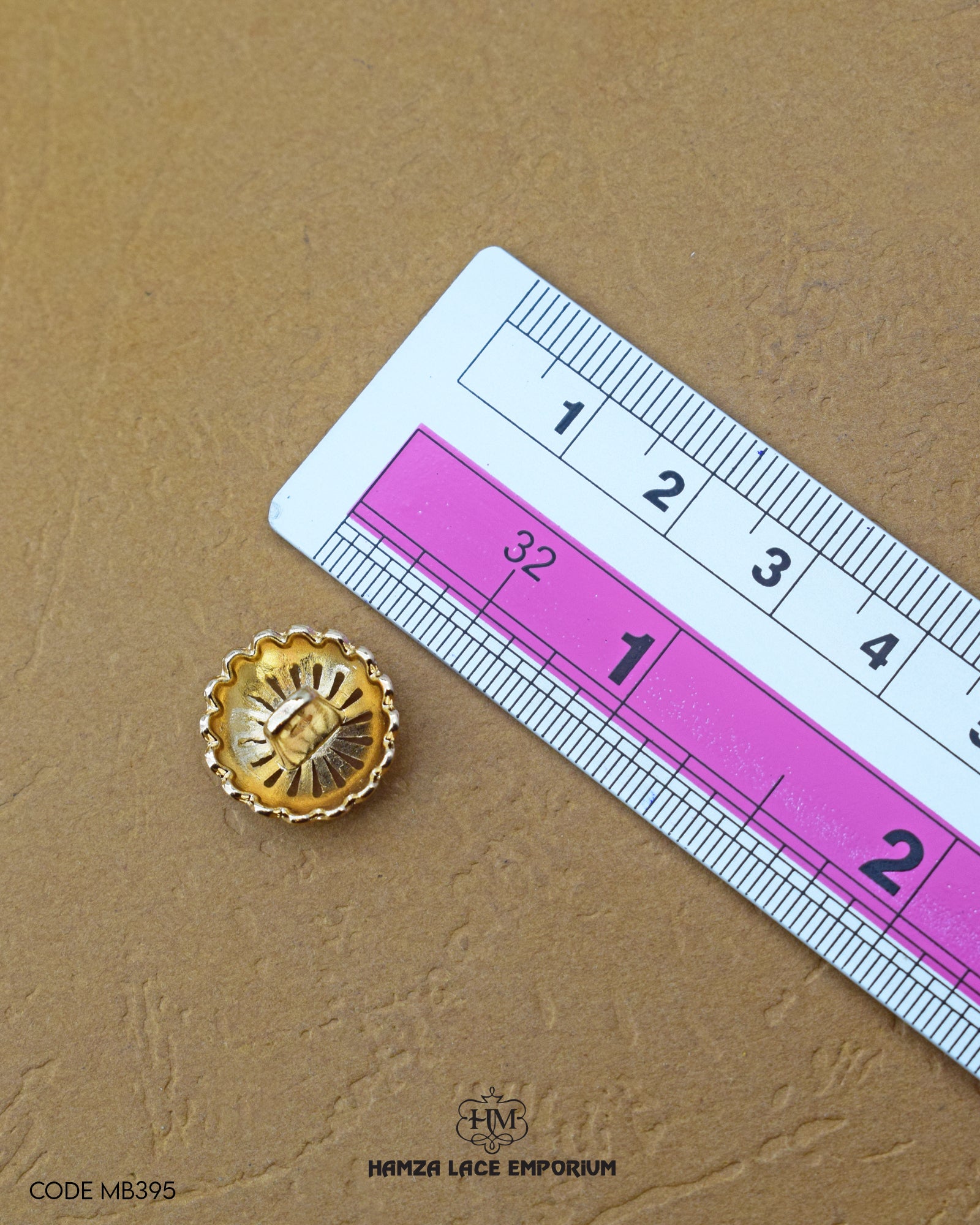 Size of the 'Flower Design Metal Button MB395' is given with the help of a ruler