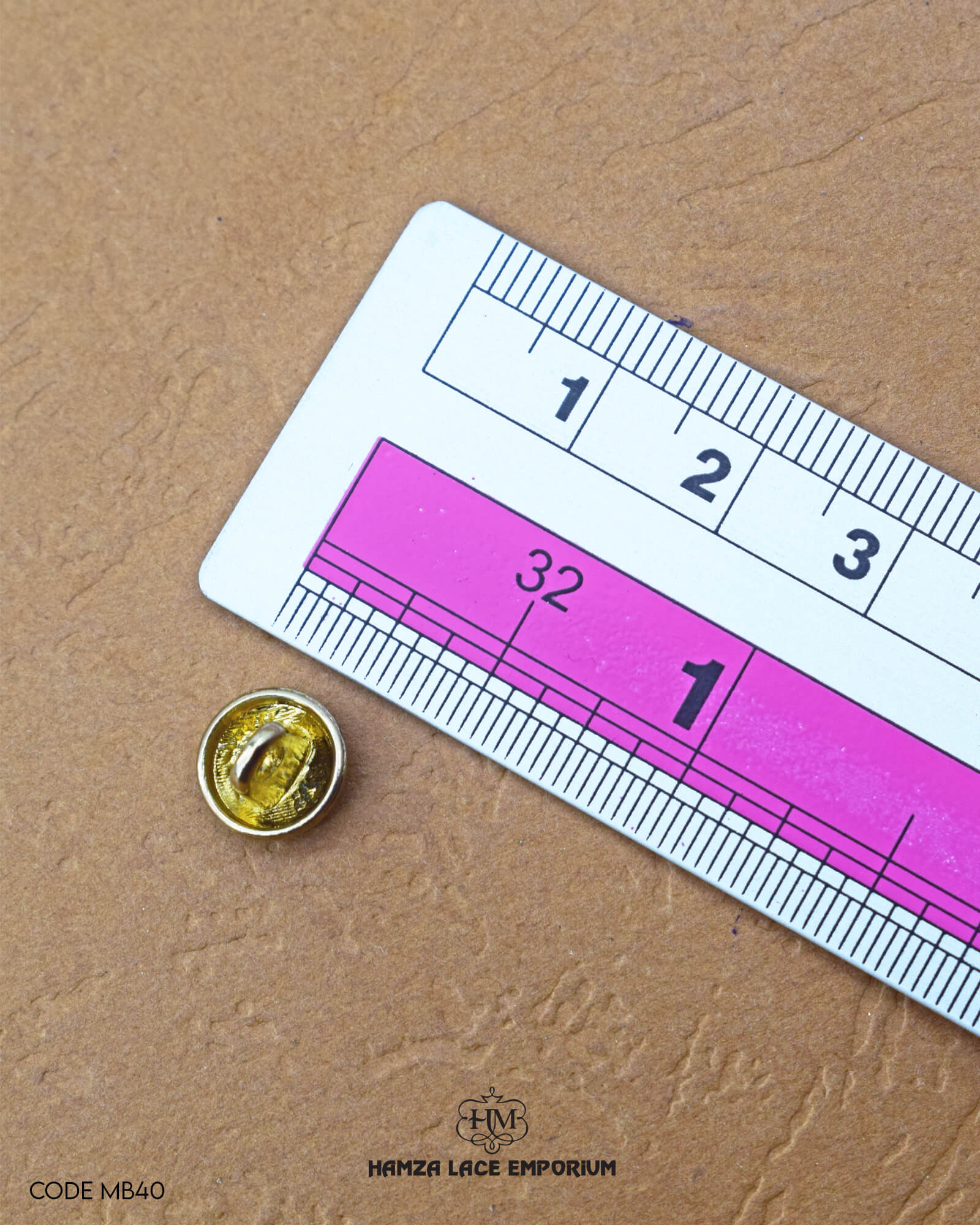 The dimensions of the 'Golden Metal Button MB40' are determined using a ruler.