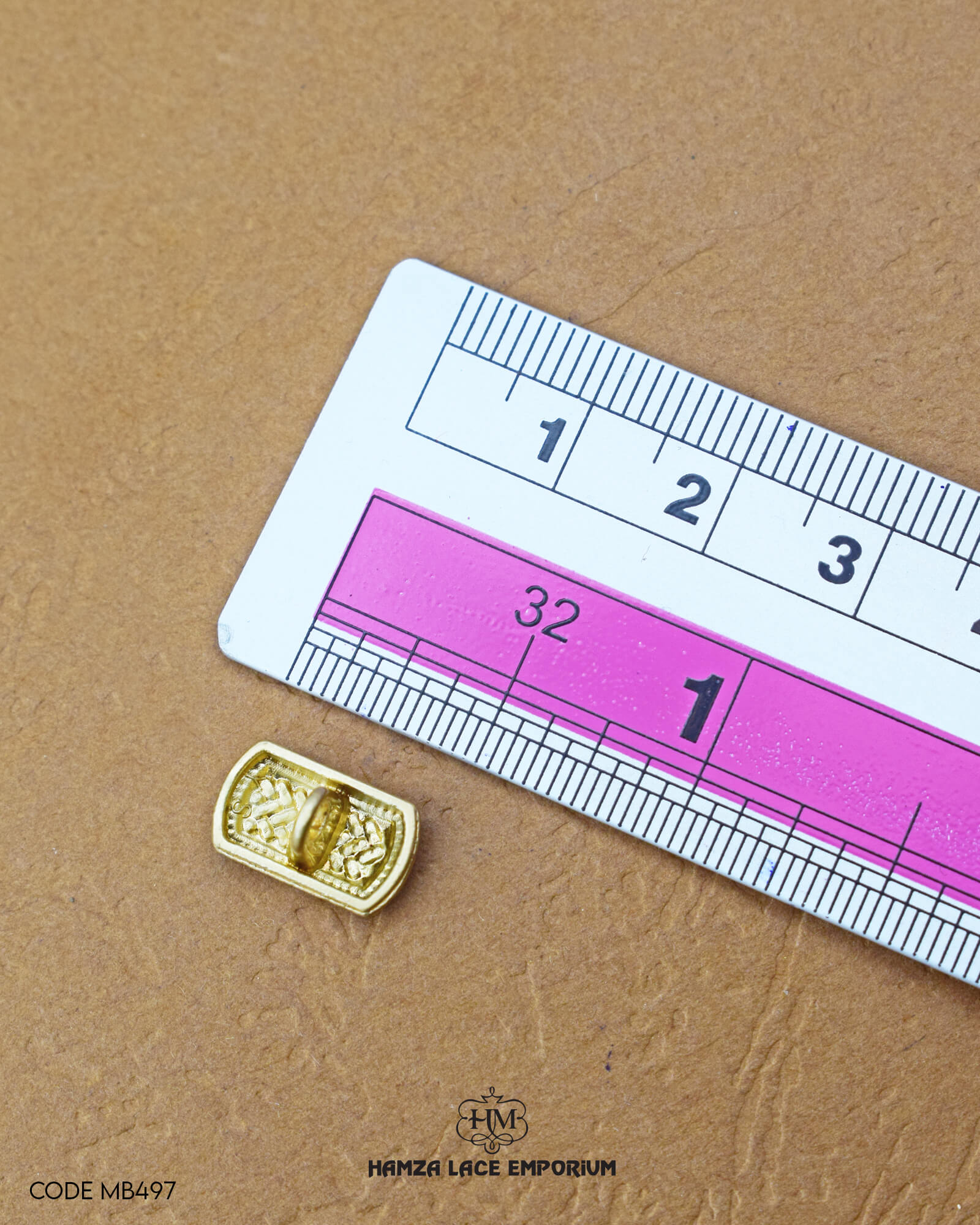 Size of the 'Golden Metal Button MB497' is given with the help of a ruler