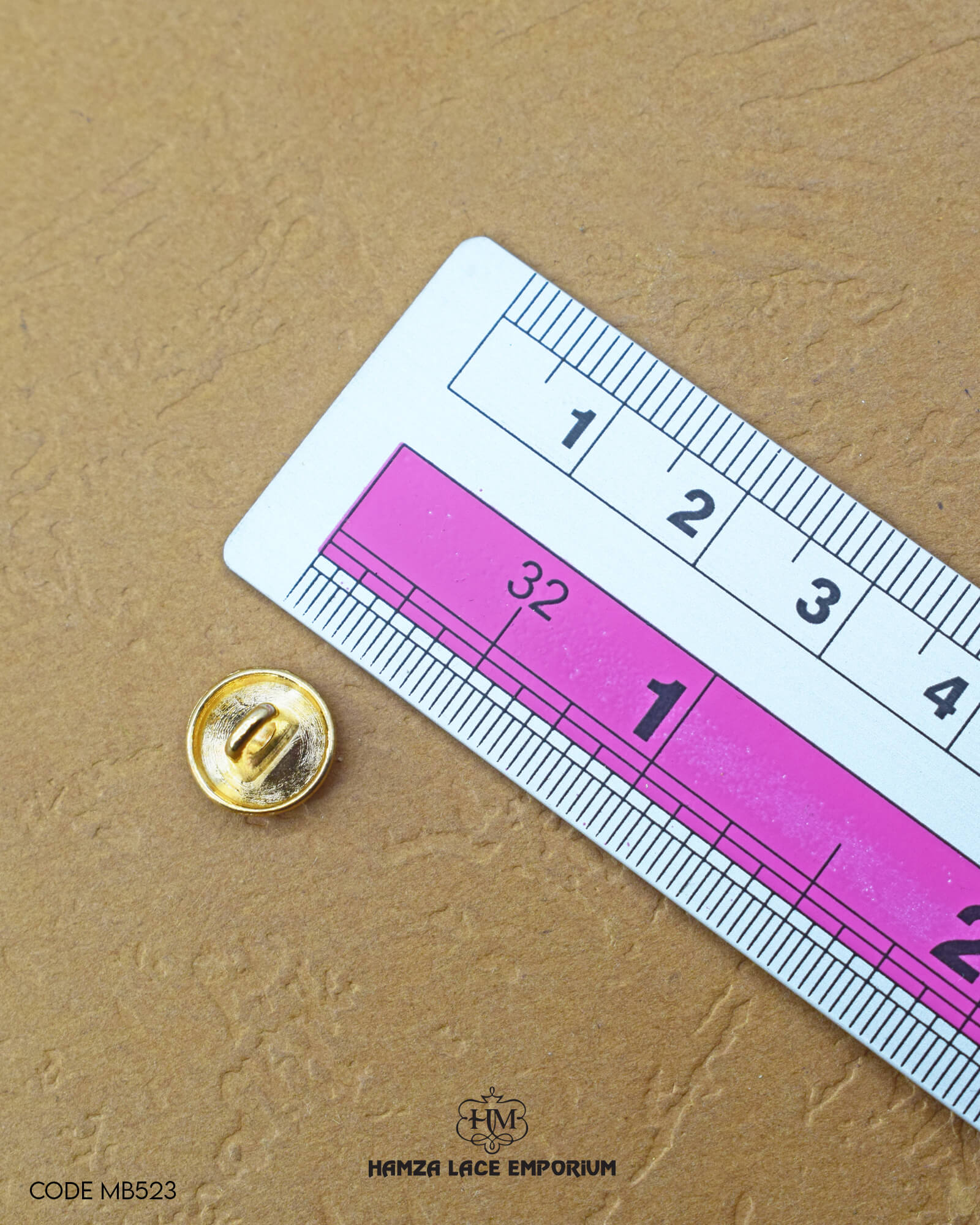 Size of the 'Golden Metal Button MB523' is given with the help of a ruler