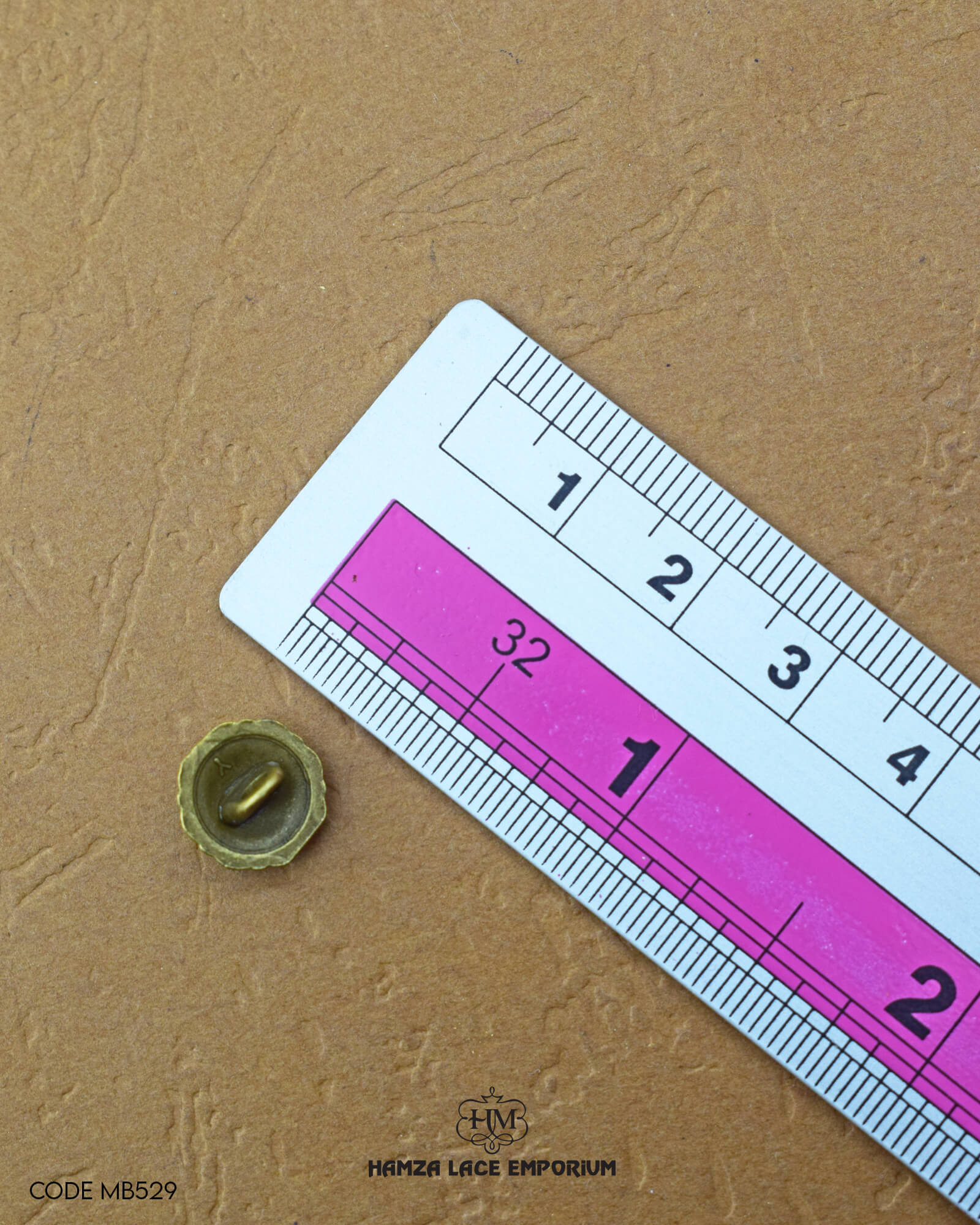 Size of the 'Antique Metal Button MB529' is given with the help of a ruler