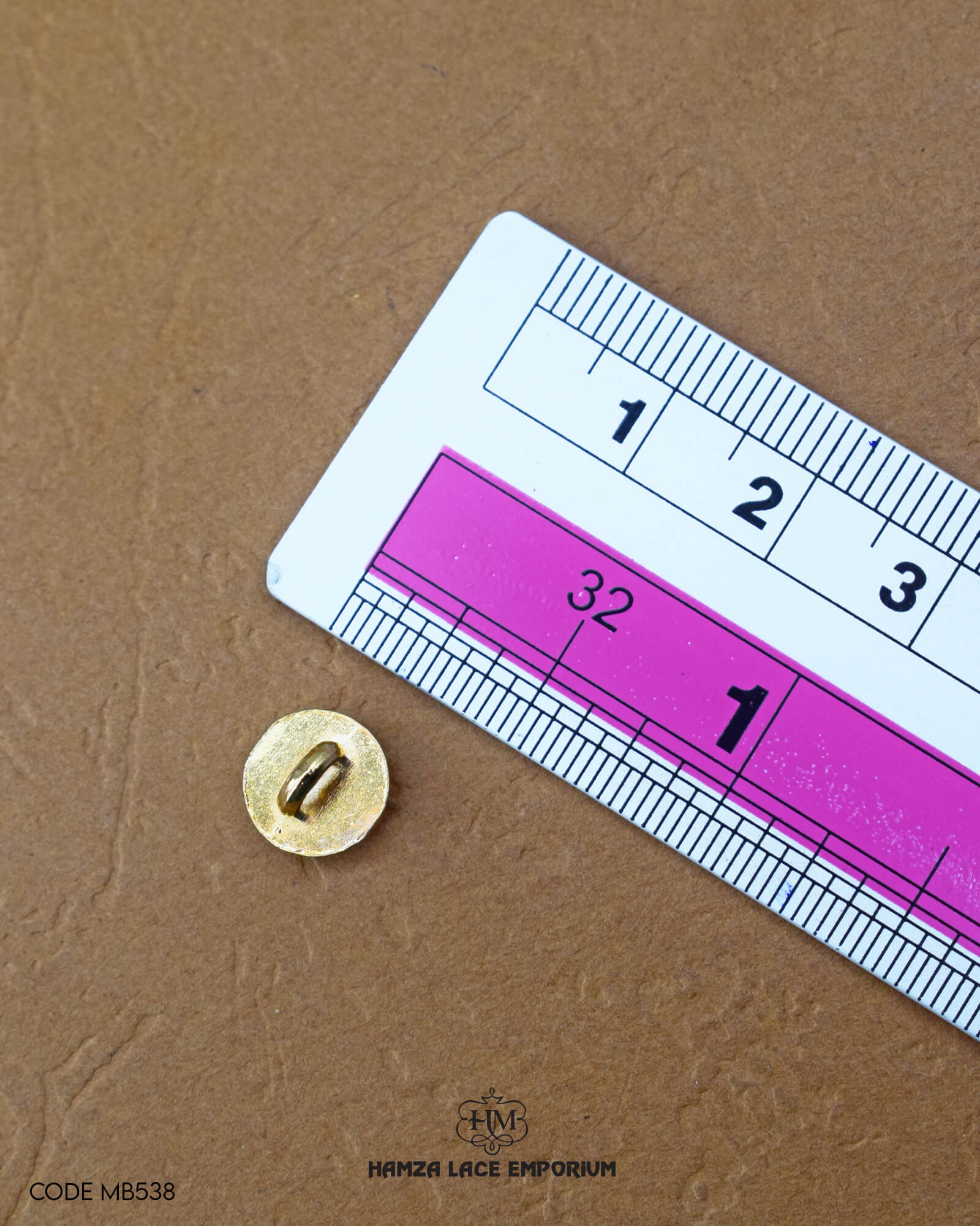 The size of the 'Metal Suiting Button MB544' is measured by using a ruler