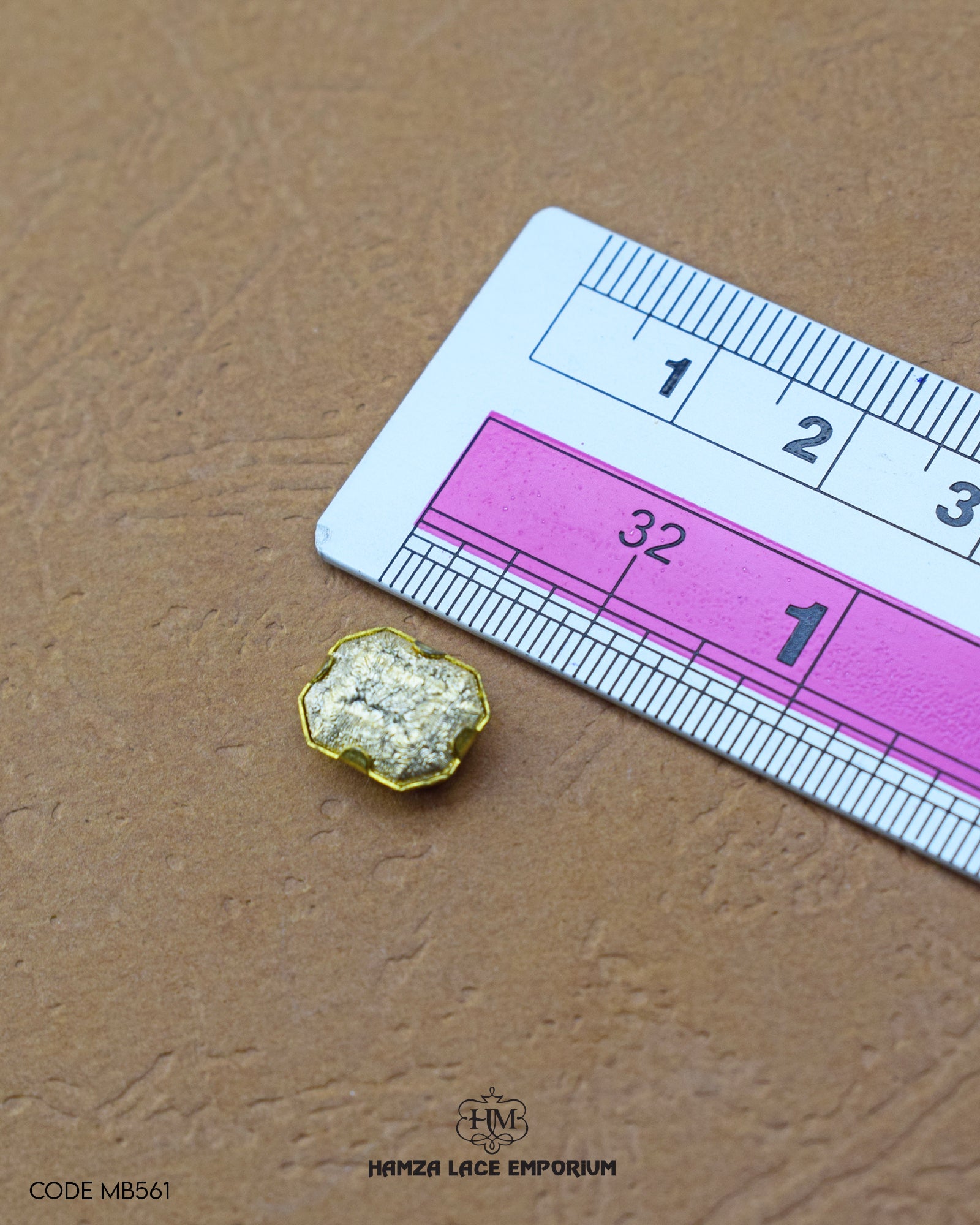 Size of the 'Metal Button MB561' is given with the help of a ruler