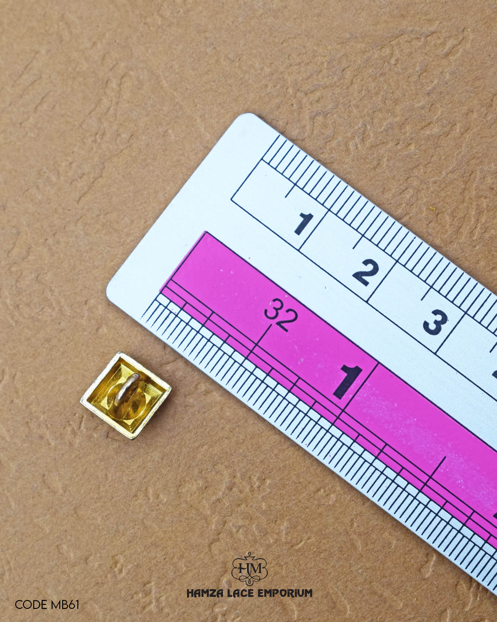 The size of the 'Golden Metal Button MB61' is measured by using a ruler