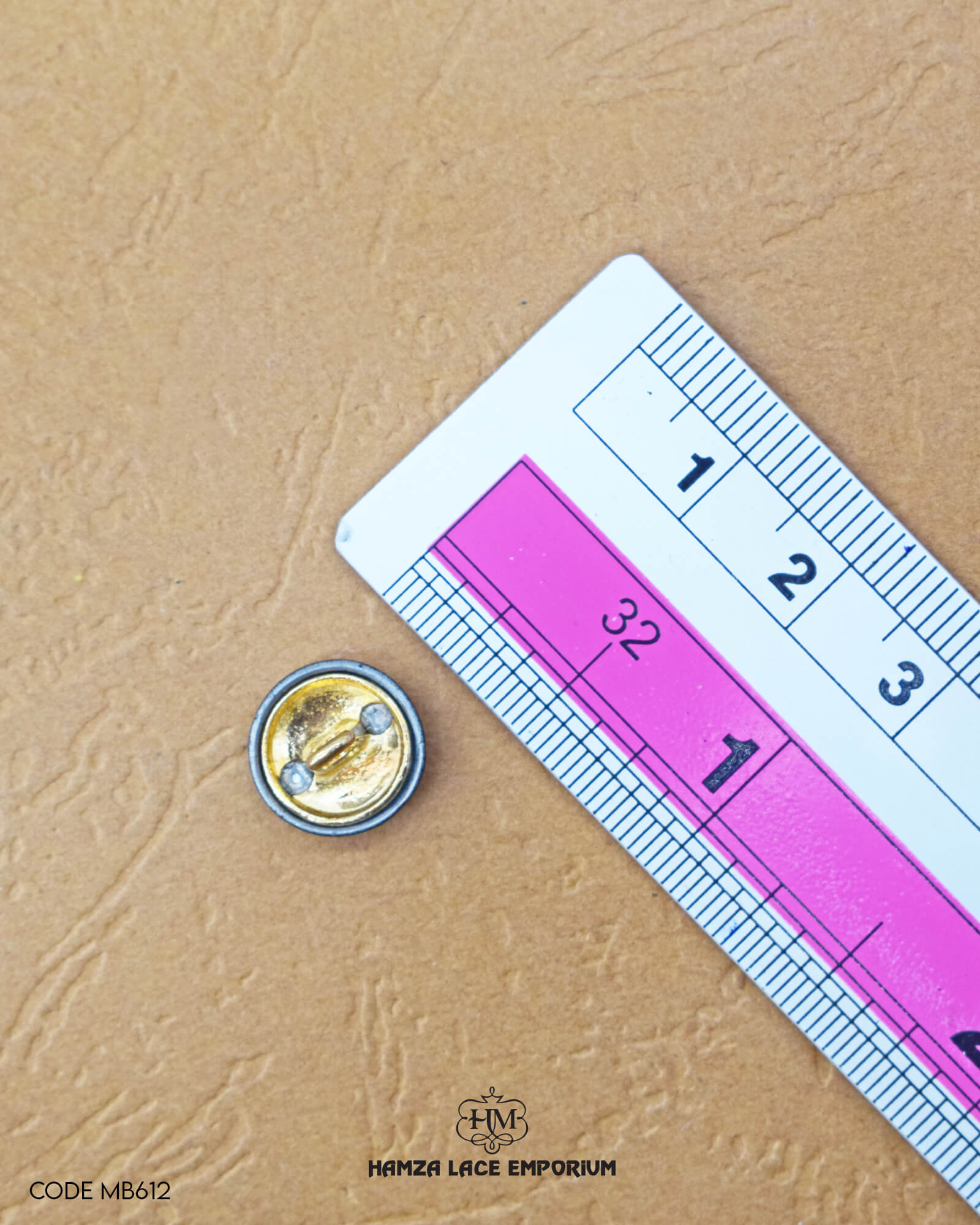 The size of the 'Metal Suiting Button MB612' is measured using a ruler.