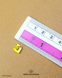 The dimensions of the 'Metal Suiting Button MB630' are determined using a ruler.