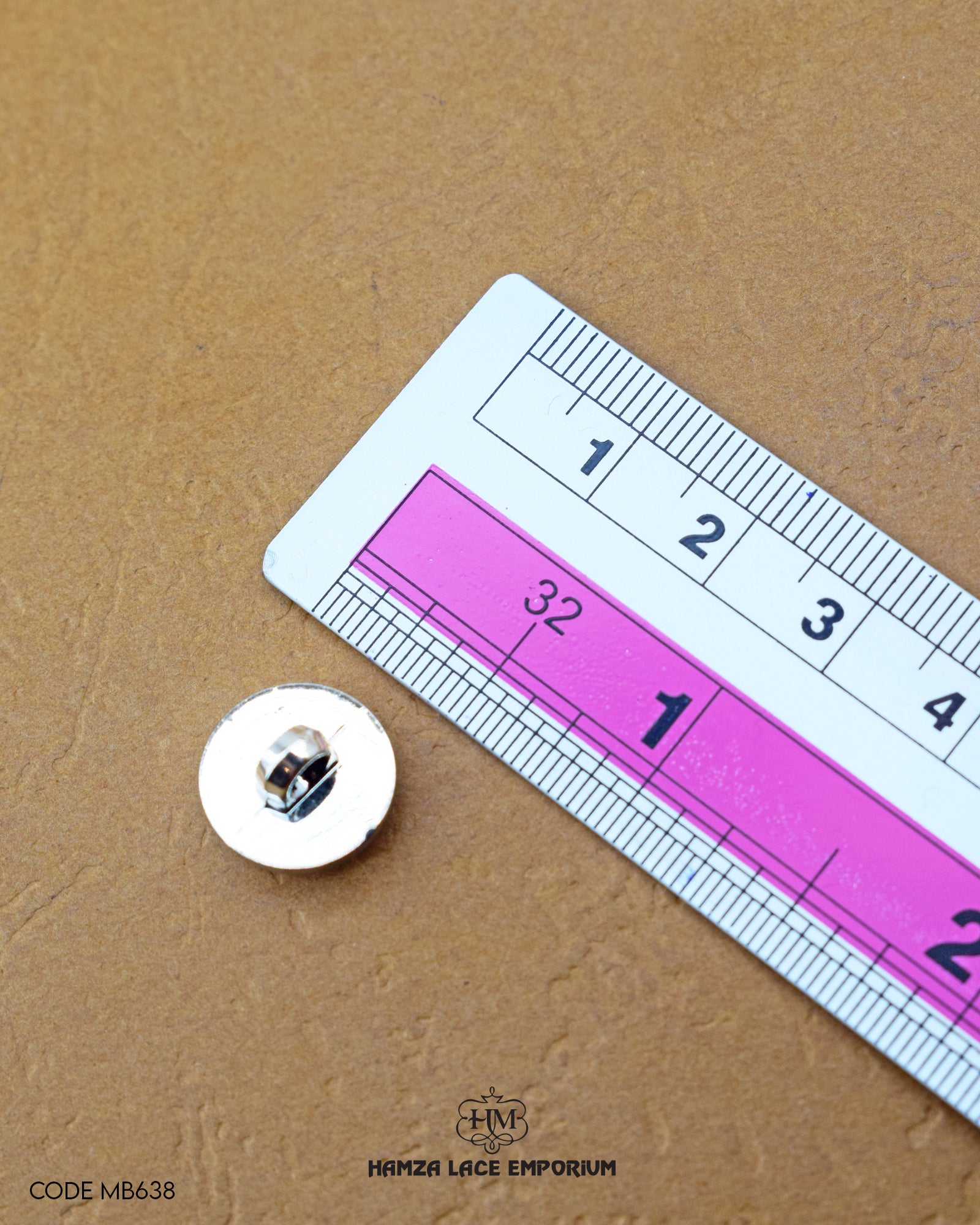Size of the 'Metal Suiting Button MB638' is given with the help of a ruler