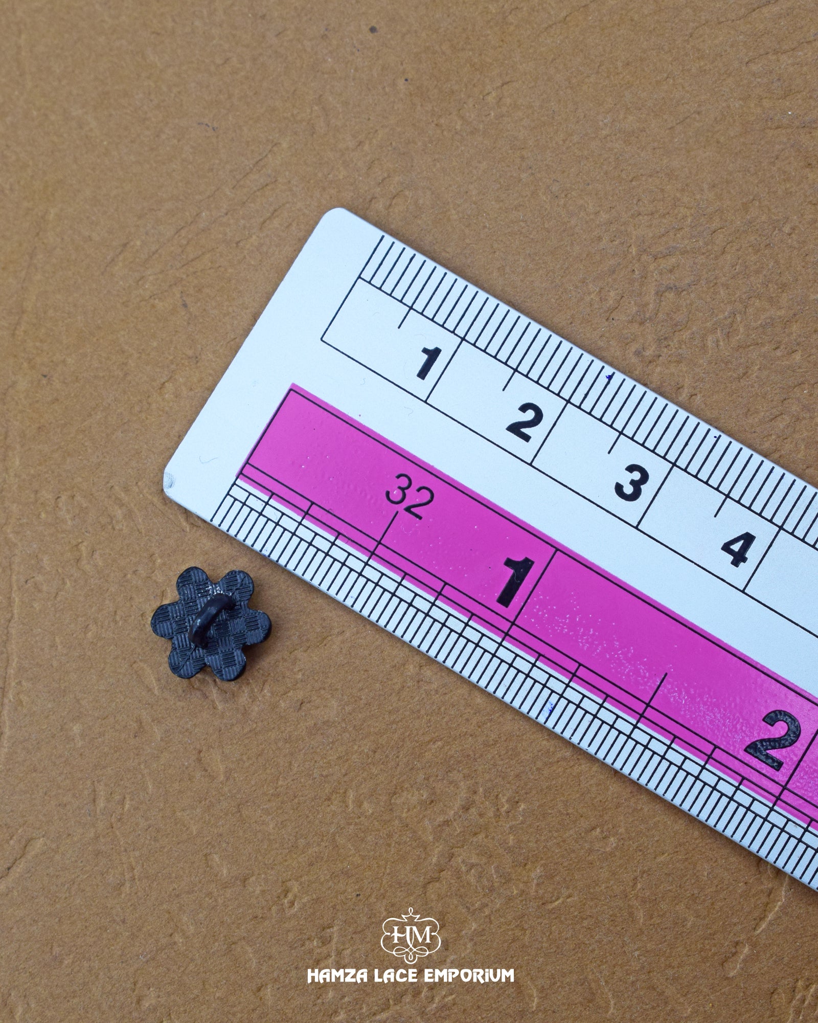 The size of the 'Flower Design Plastic Button MB641' is measured using a ruler.