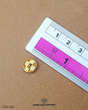 The size of the 'Golden Metal Button MB65' is measured by using a ruler