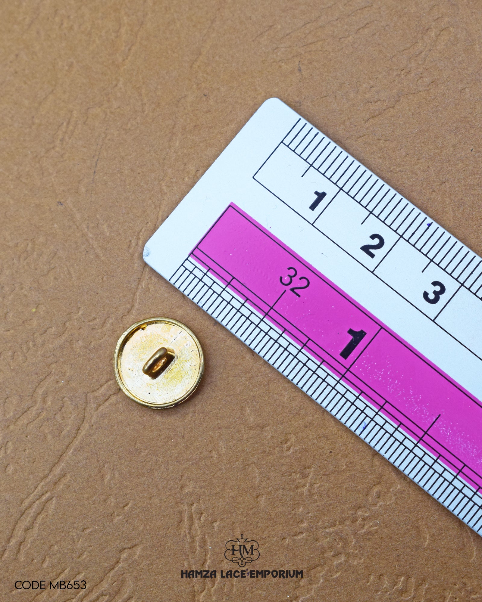 The size of the 'Golden Plane Metal Button MB653' is measured using a ruler