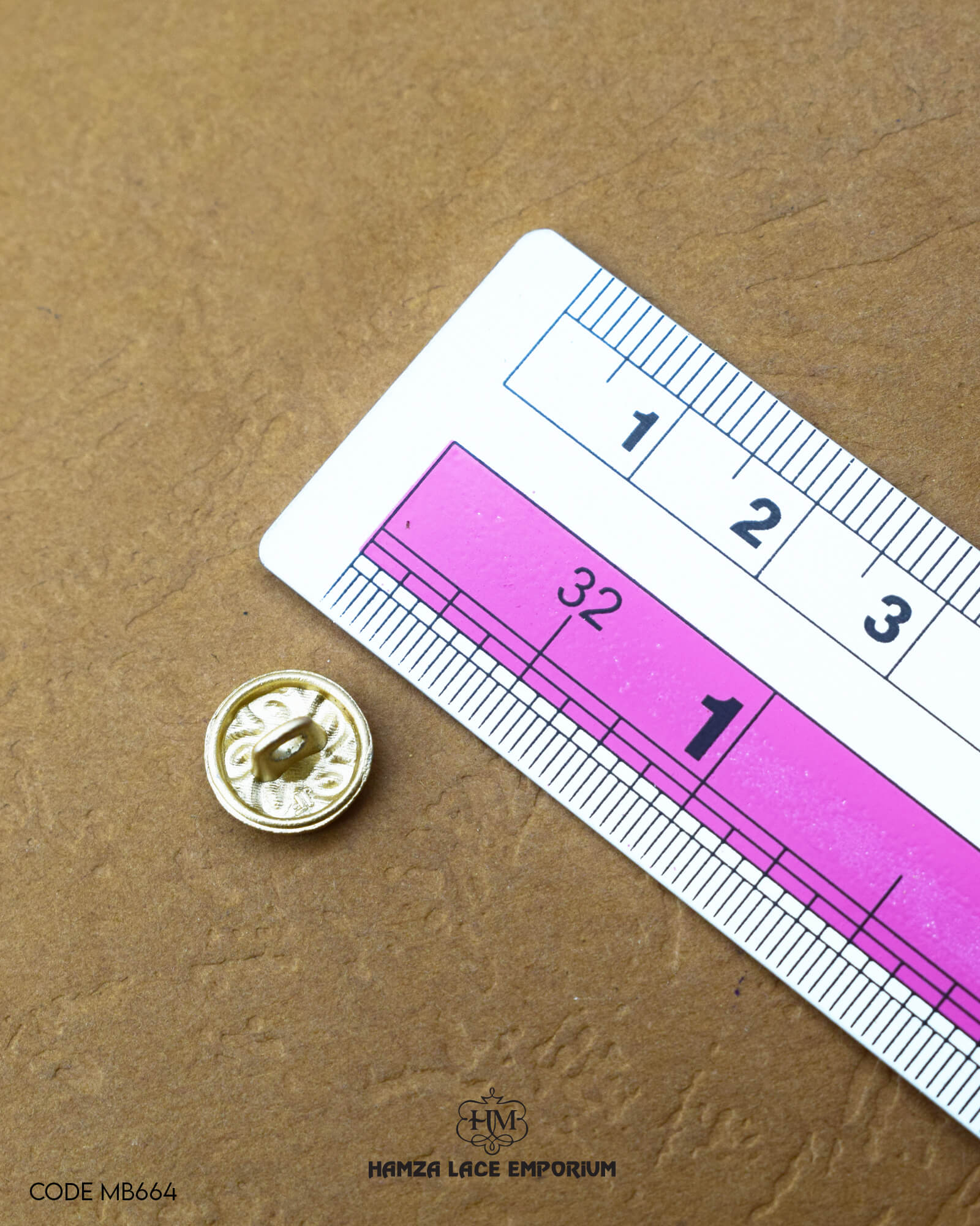 The dimensions of the 'Flower Design Button MB664' are determined using a ruler.
