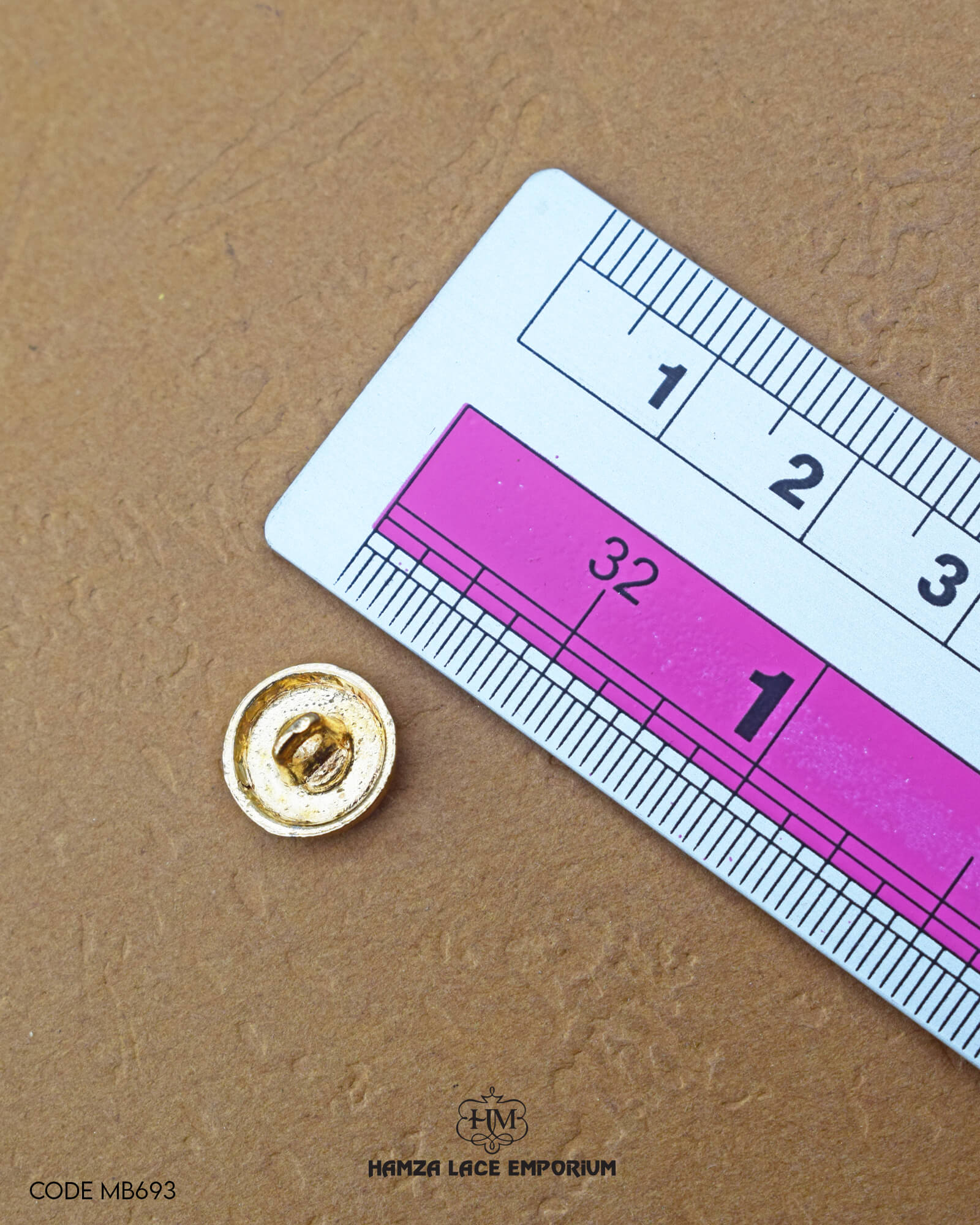 The size of the 'Metal Suiting Button MB693' is measured by using a ruler