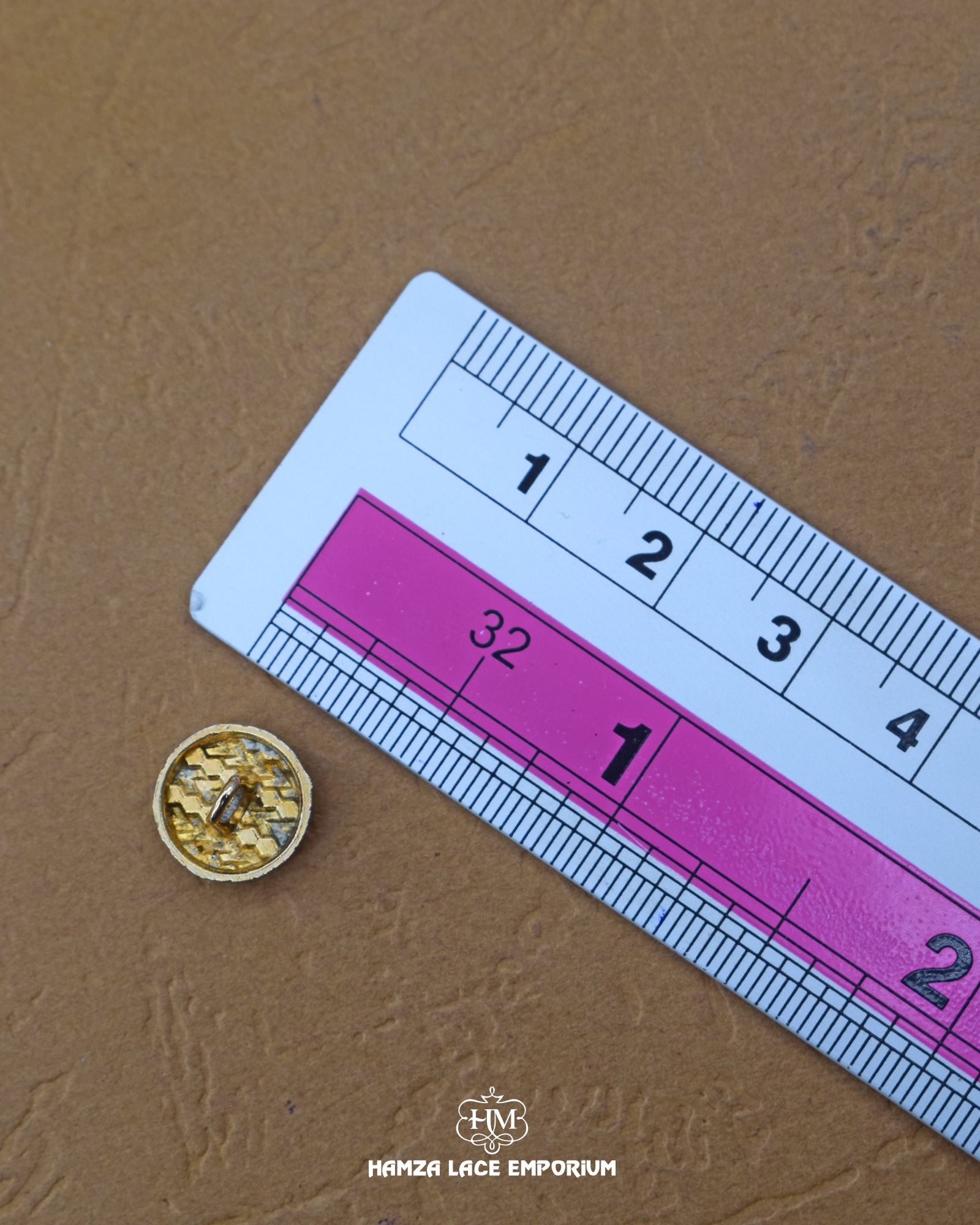 The size of the 'Dotted Metal Button MB696' is measured using a ruler.