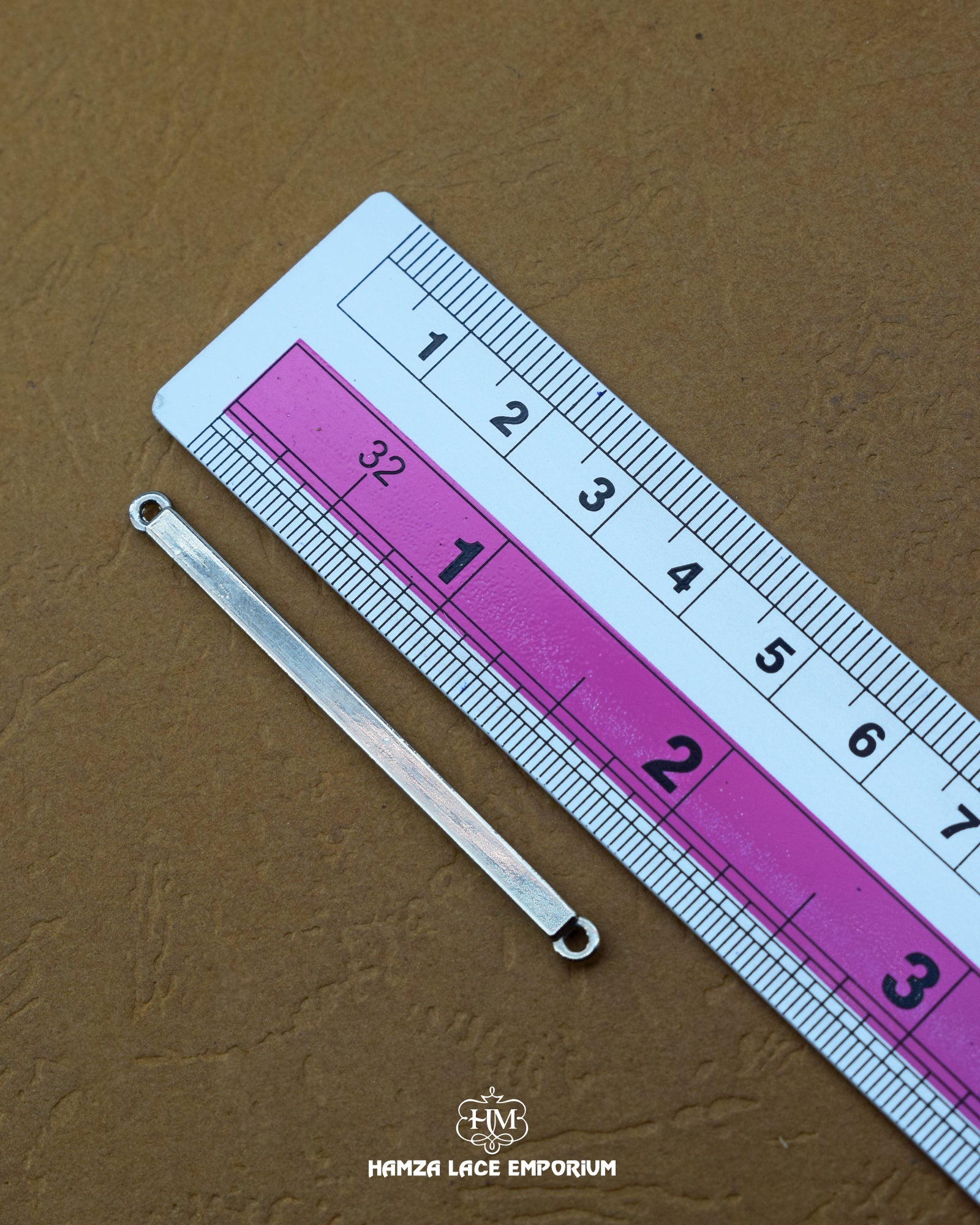 The dimensions of the 'Metal Hanging MB702' are determined using a ruler.