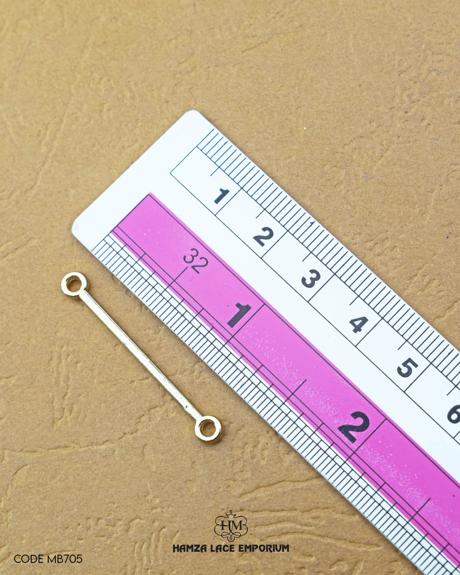 The dimensions of the 'Two Side Hole Stick MB705' are determined using a ruler.